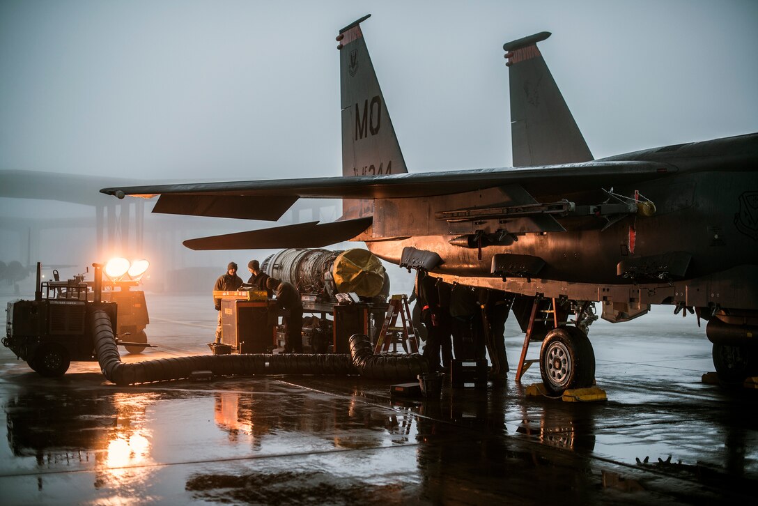 Propulsion technicians service an F-15E Strike Eagle engine Dec. 18, 2013, at Mountain Home Air Force Base, Idaho.  Proper and frequent maintenance is essential to sustain the aging Strike Eagle fleets, and 366th Maintenance Group Airmen ensure F-15Es are ready to fly at a moment’s notice. (U.S. Air Force photo/Master Sgt. Kevin Wallace)