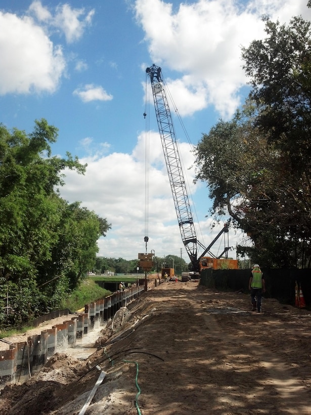 At the Wares Creek Flood Control Project in Bradenton, Fla., crews drive sheet pile along the west side of the channel. Each of three phases of the project was awarded to an 8(a) small business firm.