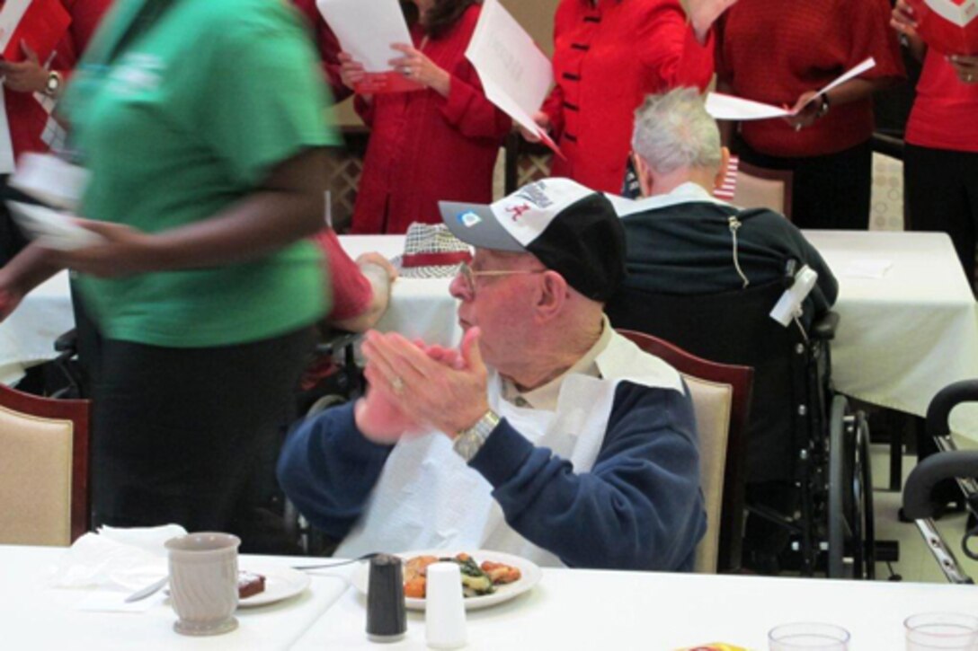 Huntsville Center employees visited residents of the Floyd E. "Tut" Fann Alabama State Veterans Home, Huntsville, Ala. Dec. 20 following the Holiday Town Hall gathering at the University of Alabama-Huntsville Student Center. Huntsville Center employees delivered more than 150 gift bags, put together with donations by the Center's work force, to the residents. Members of the Huntsville Center work force came together to form a Holiday Choir to sing at the town hall and outreach events.