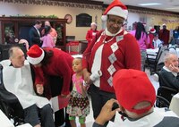 Huntsville Center employees visited residents of the Floyd E. "Tut" Fann Alabama State Veterans Home, Huntsville, Ala. Dec. 20 following the Holiday Town Hall gathering at the University of Alabama-Huntsville Student Center. Huntsville Center employees delivered more than 150 gift bags, put together with donations by the Center's work force, to the residents. Members of the Huntsville Center work force came together to form a Holiday Choir to sing at the town hall and outreach events.