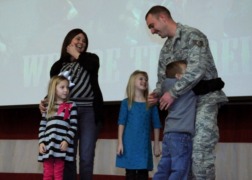 Staff Sgt. Curtis Sutton, 2nd Logistics Readiness Squadron vehicle operations control center assistance NCO in charge, hugs his son shortly after being promoted to technical sergeant under the Stripes for Exceptional Performers program at Barksdale Air Force Base, La., Jan. 3, 2014. Sutton and his family were surprised with a STEP-promotion during a 2nd Bomb Wing all-call. (U.S. Air Force photo/Senior Airman Kristin High)