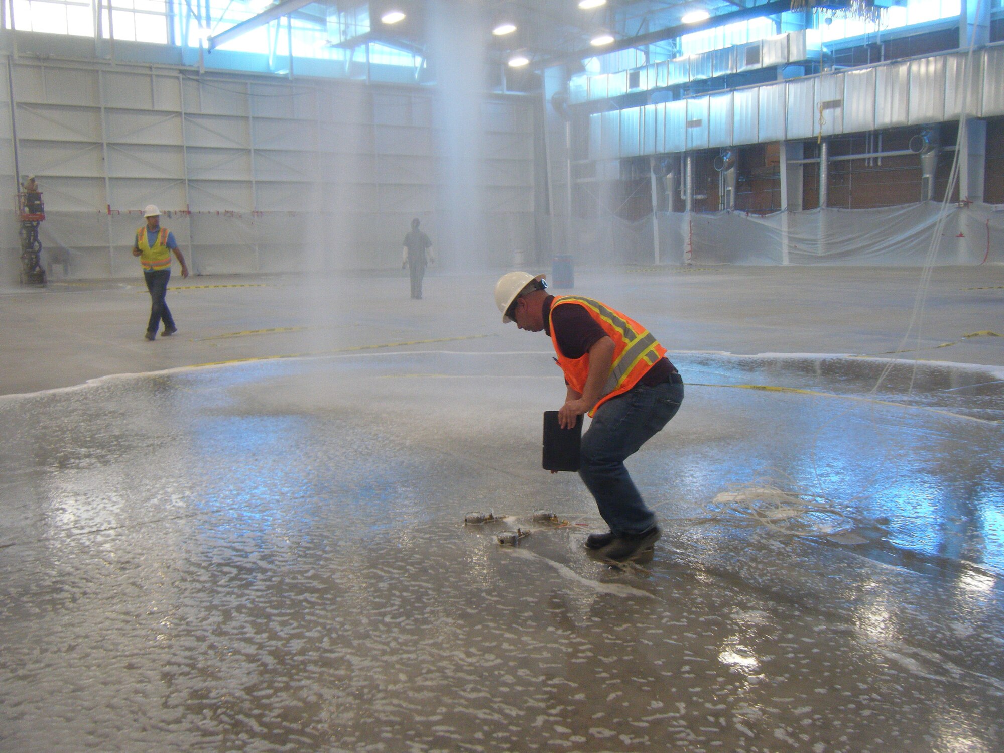 JOINT BASE SAN ANTONIO LACKLAND, Texas – A worker tests the fire suppression system water flow during inspection of the recently completed six-bay hangar at Nellis Air Force Base, Nev. The 55,000 square-foot hangar supports the installation’s F-35 beddown. (Courtesy photo)