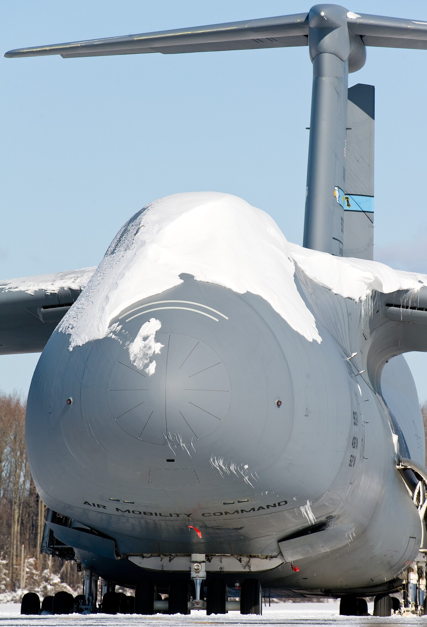 A snow-covered C-5M Super Galaxy sits on the flight line Jan. 3, 2014, at Dover Air Force Base, Del. This was the first snow storm of 2014 to hit the base. (U.S. Air Force photo/Roland Balik)