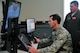 Lt Gen. Stanley Clarke III, Air National Guard Director, tries his hand at the Micro Boss, a simulator used to train boom operators at McGhee Tyson Air National Guard Base, Tennessee.  Instructing Lt. Gen. Clarke on the simulator is Master Sgt. Blue Price, a Boom Operator from the 151st Air Refueling Squadron at McGhee Tyson ANG Base. (U.S. Air National Guard photo by Master Sgt. Kendra M. Owenby, 134 ARW Public Affairs)