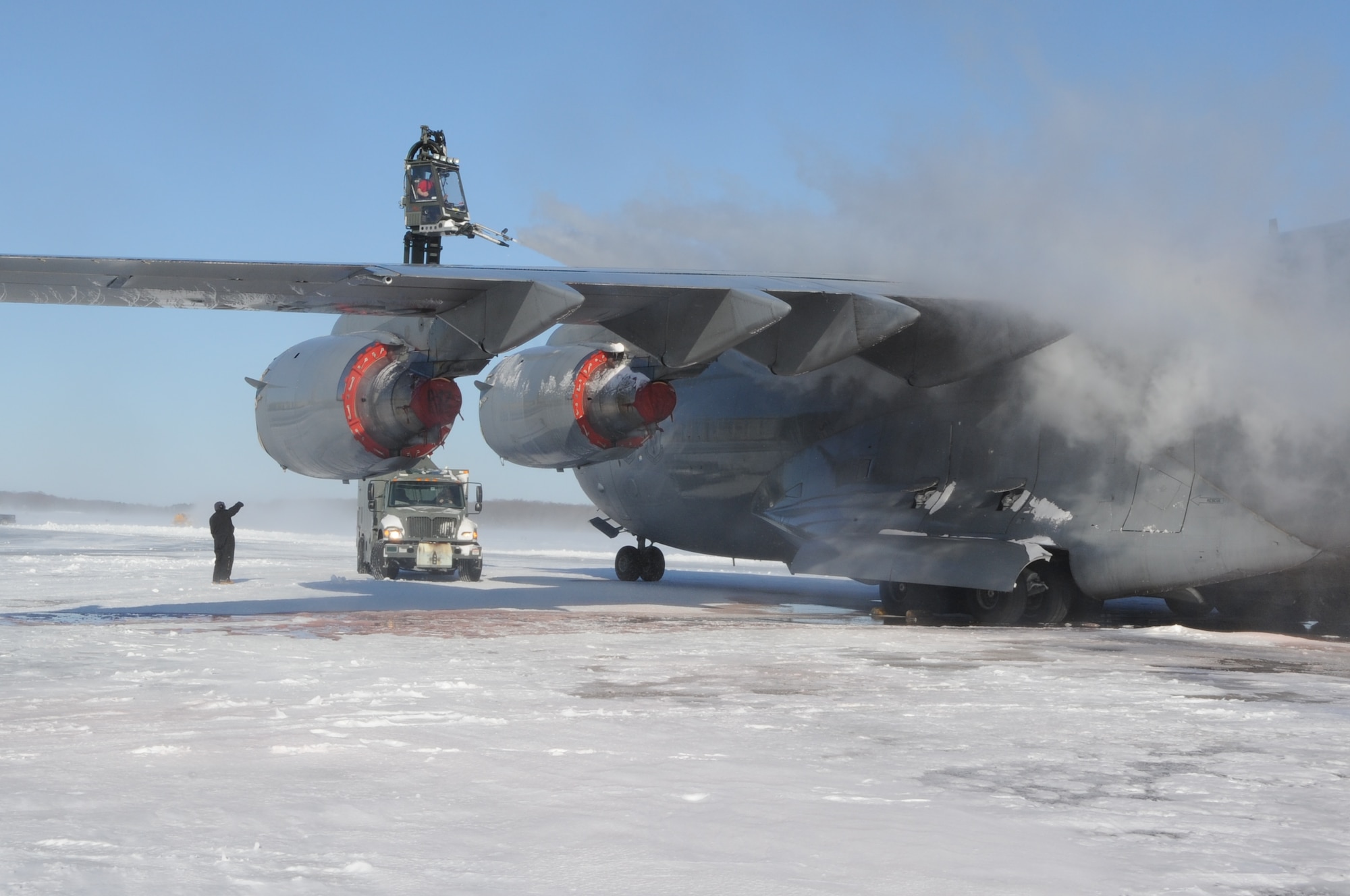 Members from the 736th Aircraft Maintenance Squadron spray deicing fluid onto the wing of a C-17A Globemaster III, based at Joint Base Lewis-McChord, Wash., Jan. 3, 2014, at Dover Air Force Base, Del. The deicing fluid removes built-up ice and snow from the aircraft in order to make it flight-ready. (U.S. Air Force photo/Airman 1st Class Zachary Cacicia) 