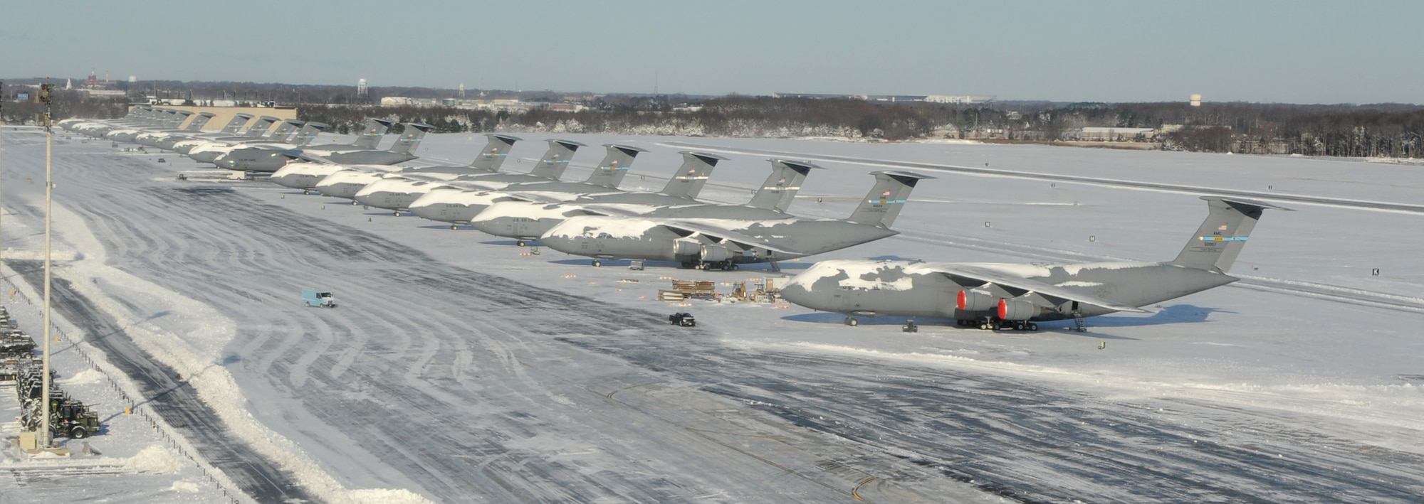 9 C-5M Super Galaxies and 10 C-17A Globemaster IIIs sit on the flight line covered in snow Jan. 3, 2014, at Dover Air Force Base, Del. 4 inches of snow fell onto Dover the night before, in what was the East Coast’s first snowstorm of the year. (U.S. Air Force photo/Airman 1st Class Zachary Cacicia)