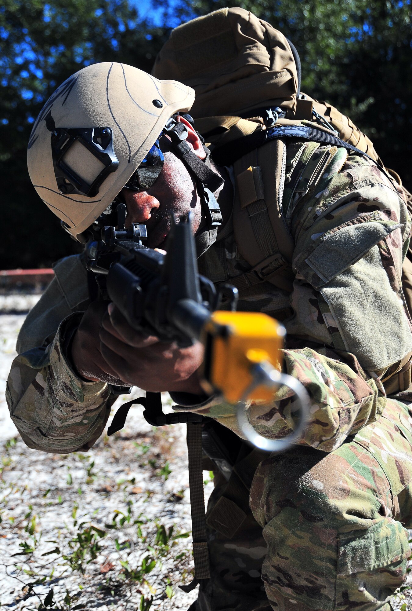 Staff Sgt. Darius Bailey, 325th Fighter Wing explosive ordnance disposal apprentice, provides protection against enemies while an improvised explosive device is being disarmed Dec. 20, at Tyndall. The 325th FW EOD unit trains in multiple areas to stay current with the constant changes in enemy strategy. (U.S. Air Force photo by Airman 1st Class Sergio A. Gamboa)
