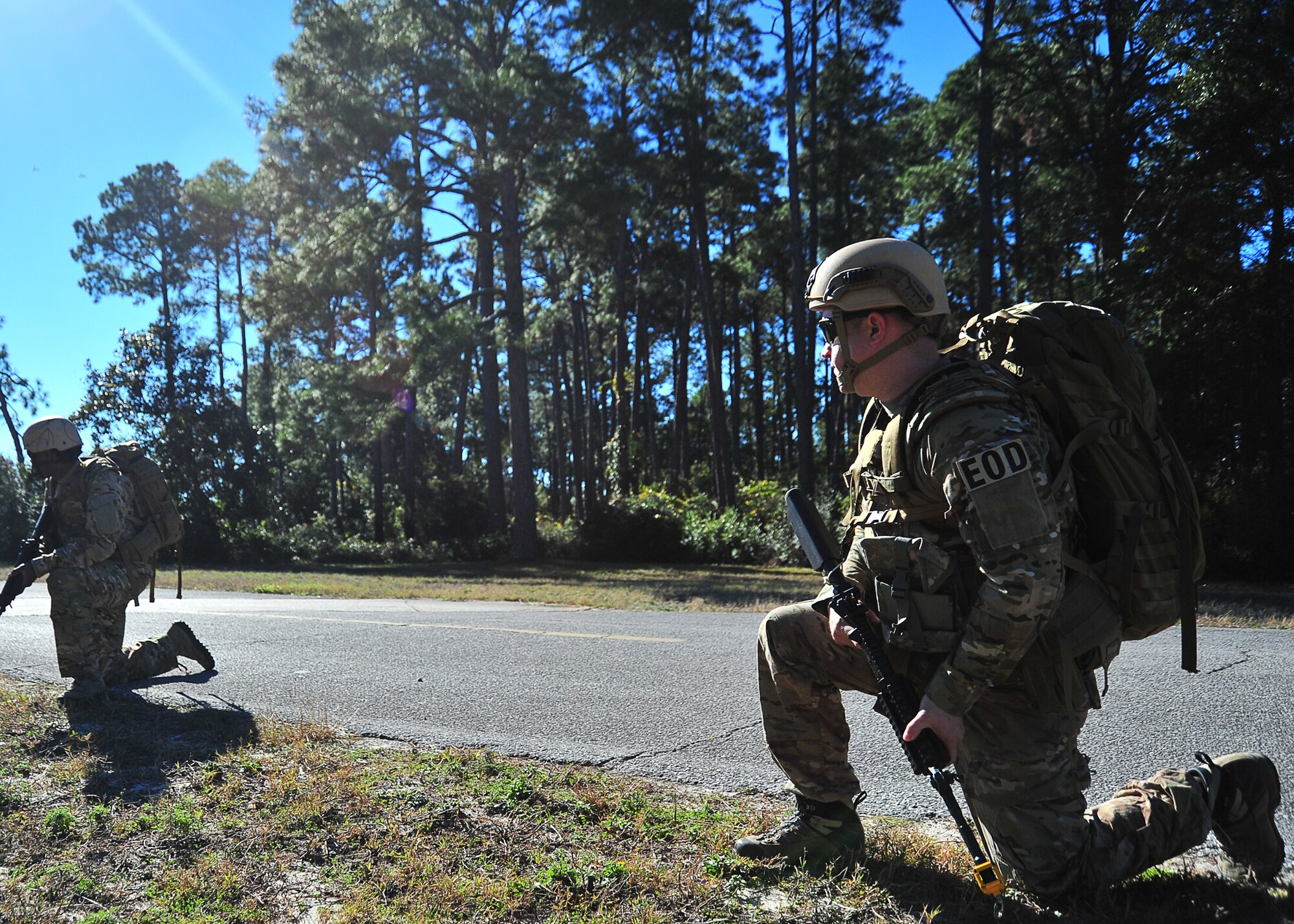 Tech. Sgt. Phillip Dyer, 325th Fighter Wing explosive ordnance disposal craftsman, kneels down on watch keeping an eye out for potential enemy in a simulated scenario Dec. 20, at Tyndall. The 325th FW EOD unit trains in multiple areas to stay current with the constant changes in enemy strategy. (U.S. Air Force photo by Airman 1st Class Sergio A. Gamboa)