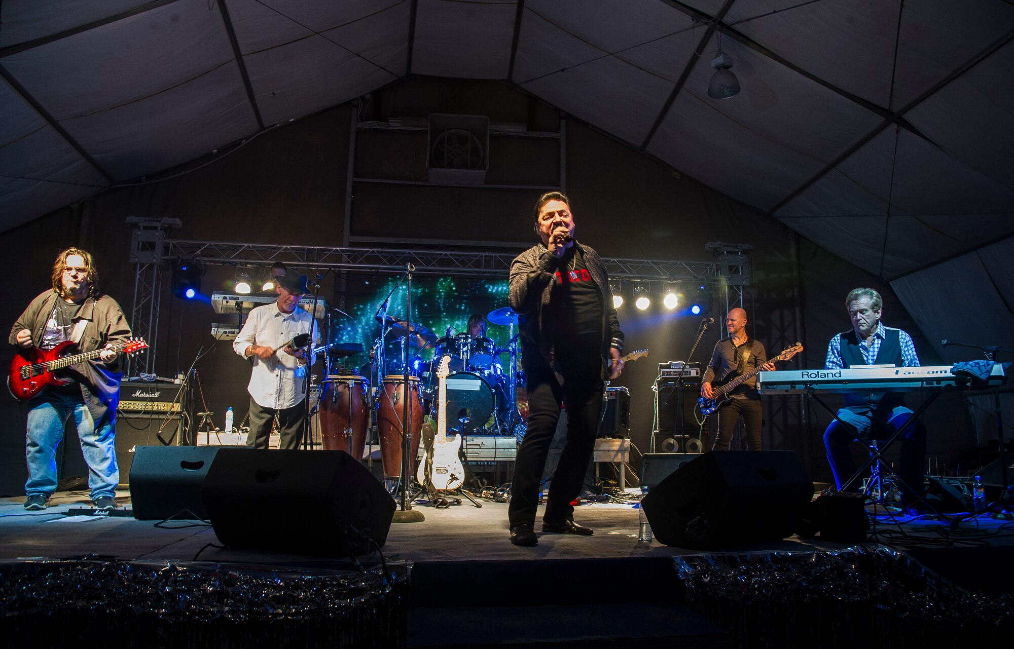 TOTO and Friends perform a concert at Transit Center at Manas, Kyrgyzstan, Dec. 31, 2013. Bobby Kimball, Alex Ligertwood and Bill Champlin performed for members of TCM to celebrate the New Year. More than 1200 Service members and civilian counterparts attended the event. (U.S. Air Force photo/Senior Airman George Goslin)
