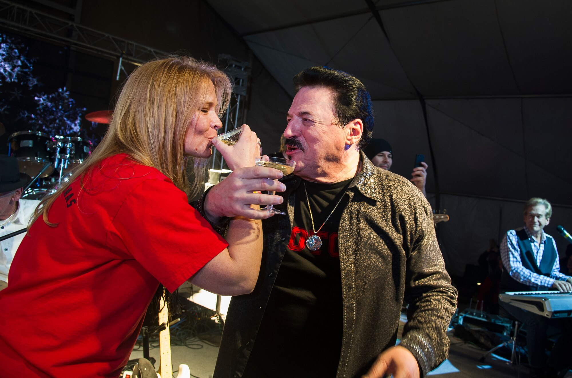 Lt. Col. Tammy Hinskton, 376th Expeditionary Force Support Squadron commander, and Bobby Kimball, TOTO frontman, celebrate the New Year with champagne during a concert at Transit Center at Manas, Kyrgyzstan, Dec. 31, 2013. Bobby Kimball, Alex Ligertwood and Bill Champlin performed for members of TCM to celebrate the New Year. More than 1200 Service members and civilian counterparts attended the event. (U.S. Air Force photo/Senior Airman George Goslin)