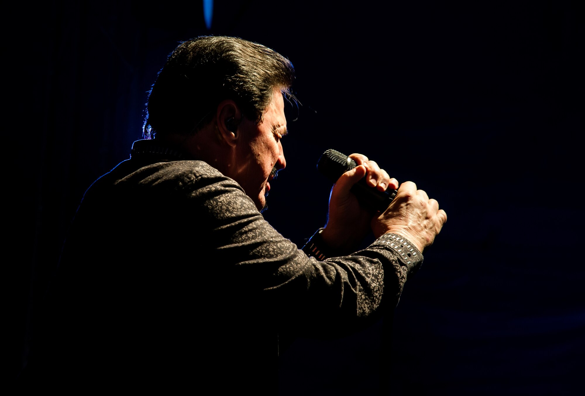 Bobby Kimball, TOTO frontman, sings during a concert at Transit Center at Manas, Kyrgyzstan, Dec. 31, 2013. Bobby Kimball, Alex Ligertwood and Bill Champlin performed for members of TCM to celebrate the New Year. More than 1200 Service members and civilian counterparts attended the event. (U.S. Air Force photo/Senior Airman George Goslin)