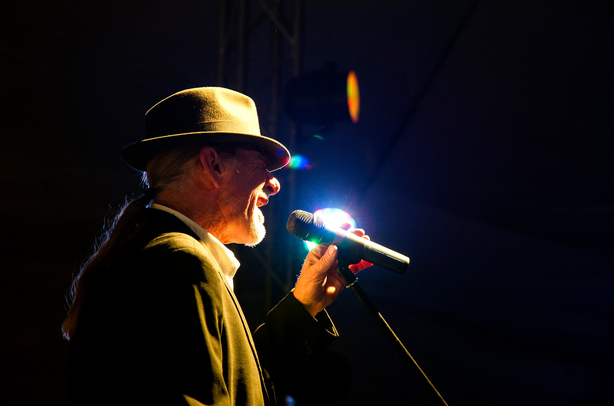 Alex Ligertwood, Santana lead vocalist, sings during a performance at Transit Center at Manas, Kyrgyzstan, Dec. 31, 2013. Bobby Kimball, Alex Ligertwood and Bill Champlin performed for members of TCM to celebrate the New Year. More than 1200 Service members and civilian counterparts attended the event. (U.S. Air Force photo/Senior Airman George Goslin)