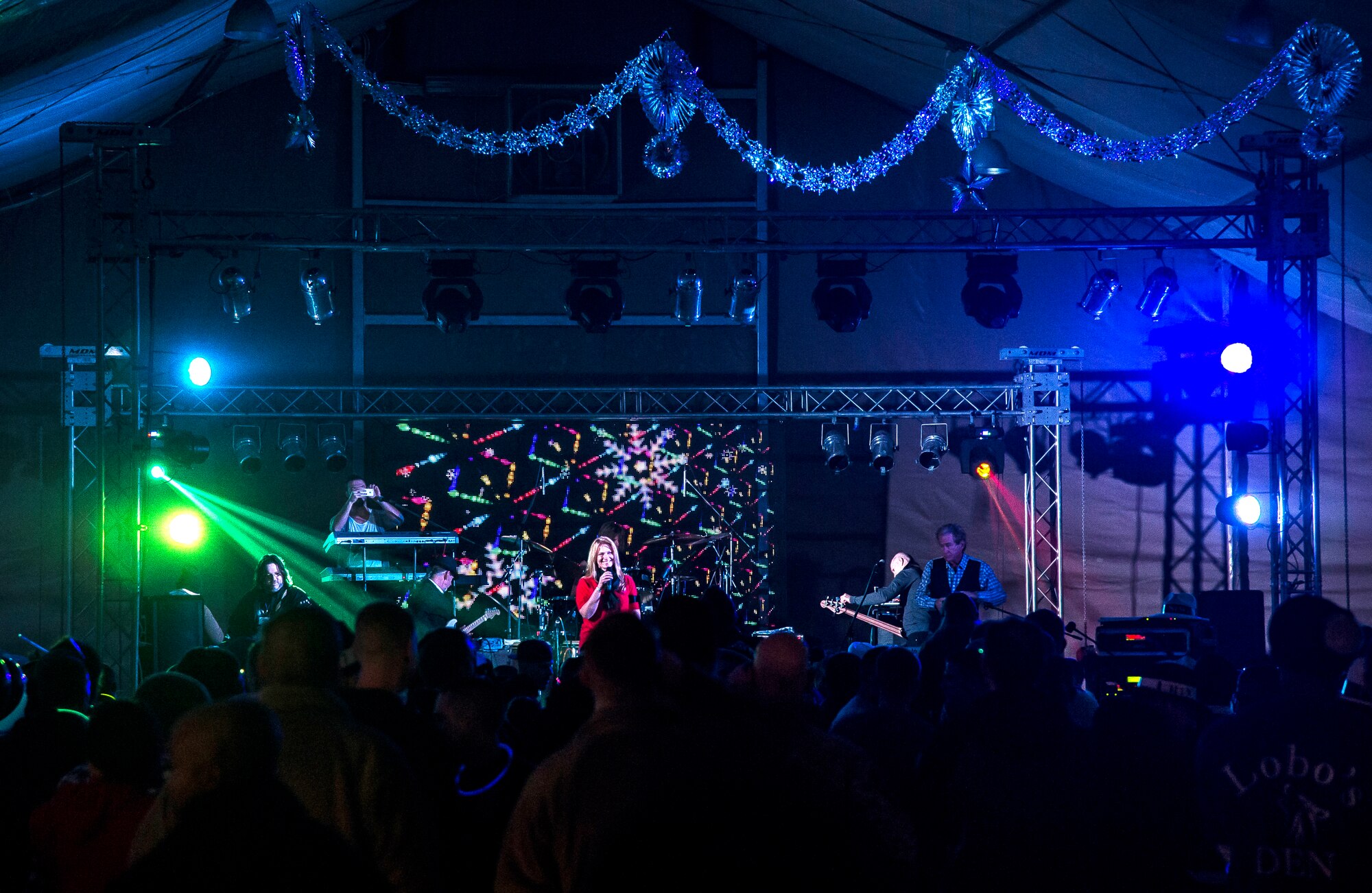 Lt. Col. Tammy Hinskton, 376th Force Support Squadron commander, announces TOTO and Friends for a performance at Transit Center at Manas, Kyrgyzstan, Dec. 31, 2013. Bobby Kimball, Alex Ligertwood and Bill Champlin performed for members of TCM to celebrate the New Year. More than 1200 Service members and civilian counterparts attended the event. (U.S. Air Force photo/Senior Airman George Goslin)