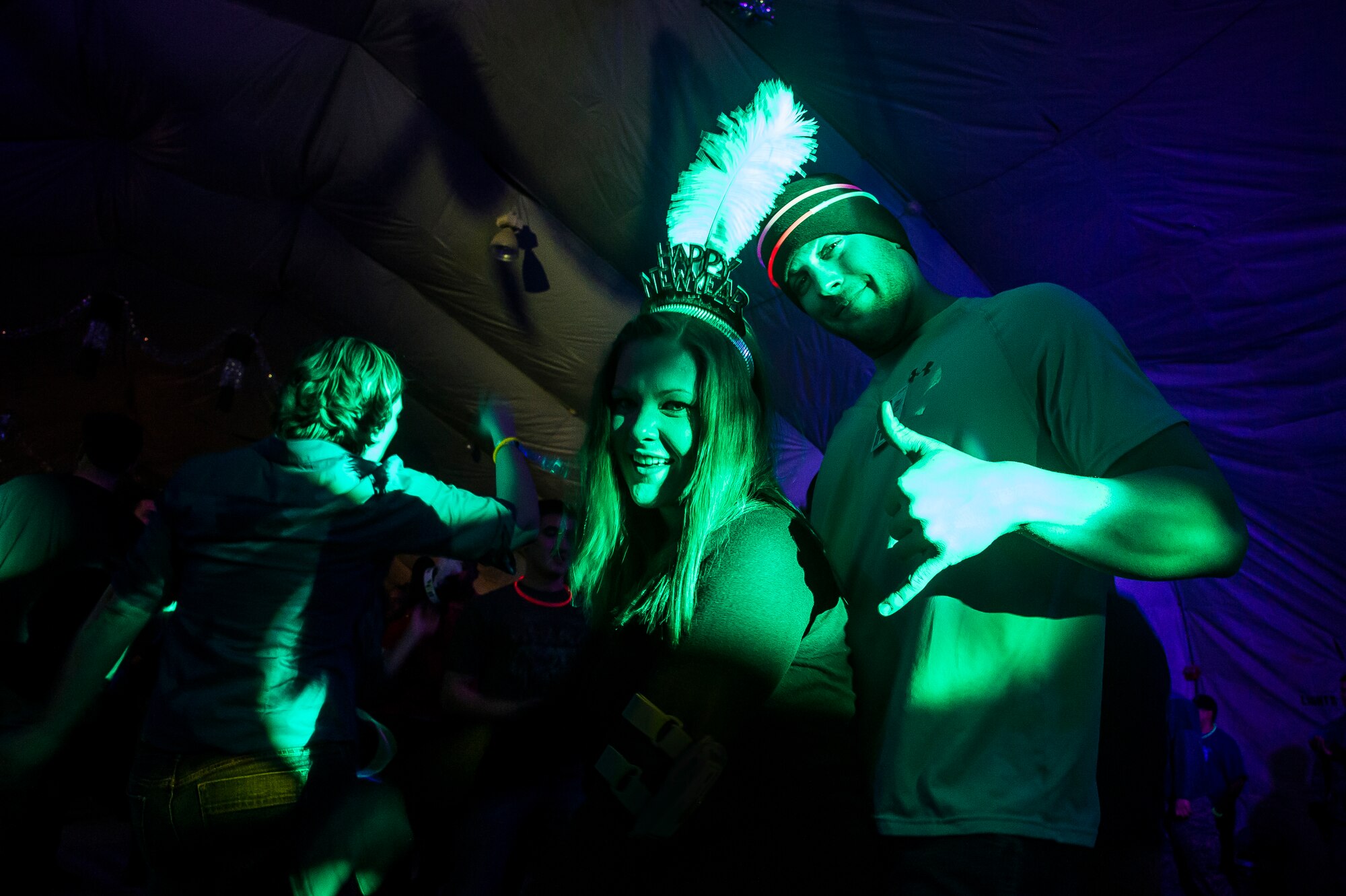 Members of the Transit Center at Manas dance during the New Year's Eve Party at TCM, Kyrgyzstan, Dec. 31, 2013. The party had dance music for attendees to dance to and glow sticks to wear before the TOTO and Friends concert. (U.S. Air Force photo/Senior Airman George Goslin)