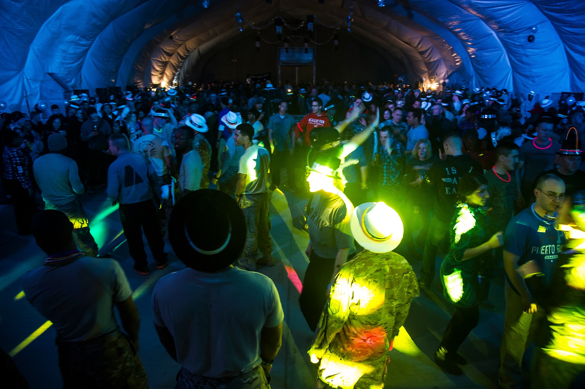 People dance during the New Year's Eve Party at Transit Center at Manas, Kyrgyzstan, Dec. 31, 2013. The party had dance music for attendees to dance to and glow sticks to wear before the TOTO and Friends concert. (U.S. Air Force photo/Senior Airman George Goslin)
