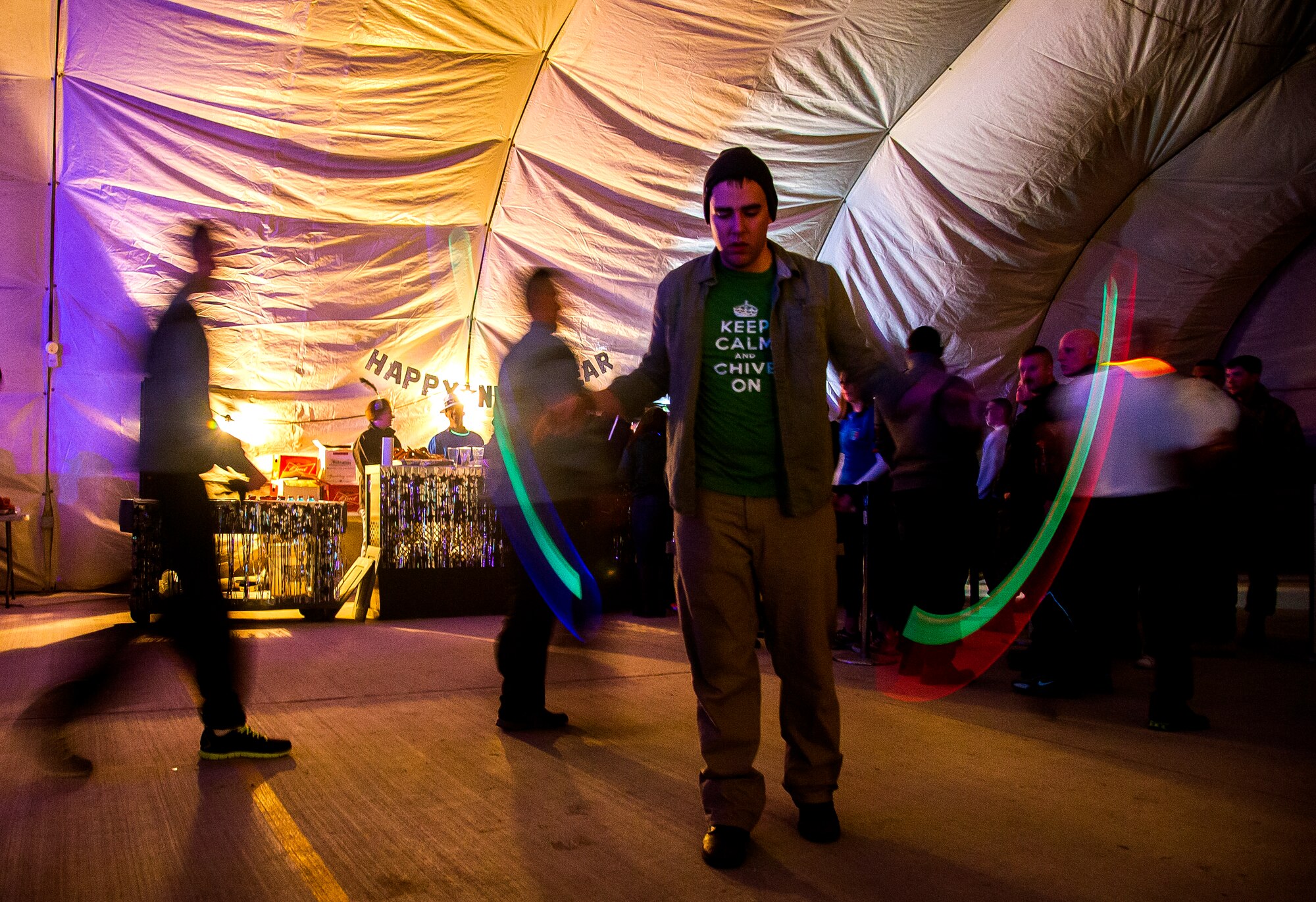 Senior Airman Ross Whitley, 376th Air Expeditionary Wing video broadcaster, spins poi during the New Year’s Eve party at Transit Center at Manas, Kyrgyzstan, Dec. 31, 2013. Bobby Kimball, Alex Ligertwood and Bill Champlin performed for members of TCM to celebrate the New Year. More than 1200 Service members and civilian counterparts attended the event. (U.S. Air Force photo/Senior Airman George Goslin)