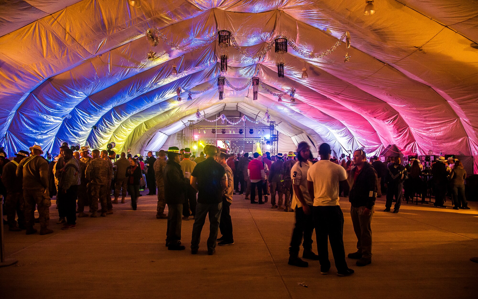 People socialize before the start of the New Year’s Eve party at Transit Center at Manas, Kyrgyzstan, Dec. 31, 2013. Bobby Kimball, Alex Ligertwood and Bill Champlin performed for members of TCM to celebrate the New Year. More than 1200 Service members and civilian counterparts attended the event. (U.S. Air Force photo/Senior Airman George Goslin)