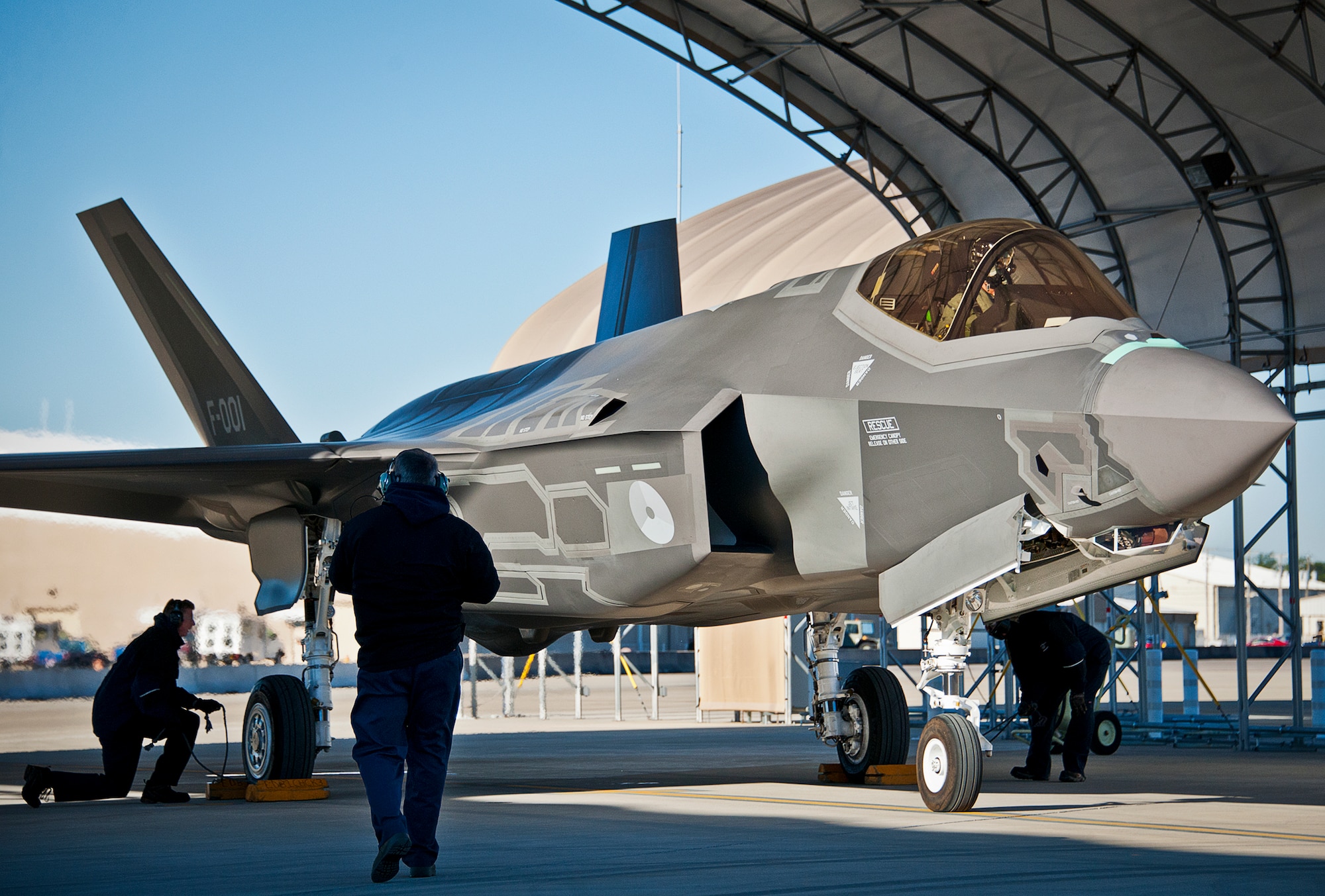 Lockheed Martin maintainers complete preflight checks on the Royal Netherlands Air Force F-35A Lightning II prior to a sortie at Eglin Air Force Base, Fla.  The RNLAF completed their first joint strike fighter flying sortie Dec. 18. (U.S. Air Force photo/Samuel King Jr.)