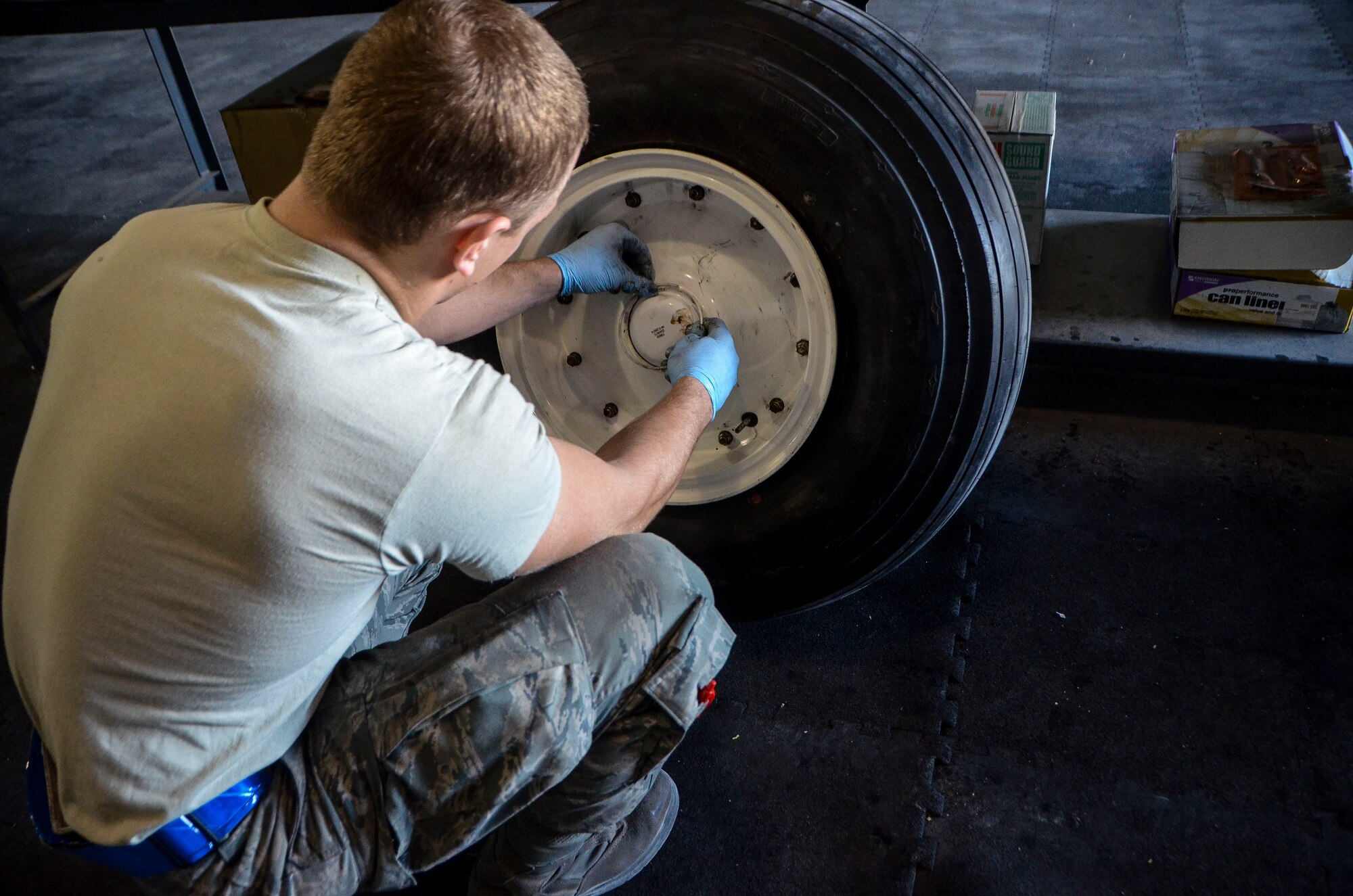 Senior Airman Adam Kern replaces a hubcap of a front wheel belonging to a C-130J Super Hercules at the 379th Air Expeditionary Wing, Dec. 31, 2013. Kern is a 379th Expeditionary Maintenance Squadron wheel and tire technician and is part of an 8-man shop which fixes and maintains all aircraft wheels for the base. Kern is deployed from Joint Base Pearl Harbor-Hickam, Hawaii, and is a Waynesville, N.C. native. (U.S. Air Force photo/Senior Airman Jared Trimarchi)