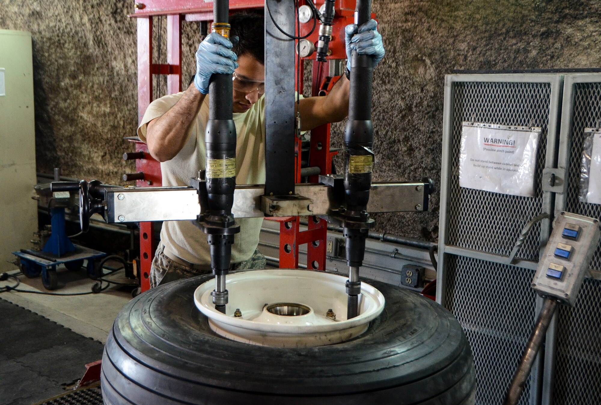 Airman 1st Class Michael Galvan assembles a front wheel belonging to a C-130J Super Hercules at the 379th Air Expeditionary Wing, Dec. 31, 2013. Galvan is a 379th Expeditionary Maintenance Squadron wheel and tire technician and is part of an 8-man shop which fixes and maintains all aircraft wheels for the base. Galvan is deployed from Joint Base Pearl Harbor-Hickam, Hawaii, and is a Santa Ana, Calif. native. (U.S. Air Force photo/Senior Airman Jared Trimarchi)