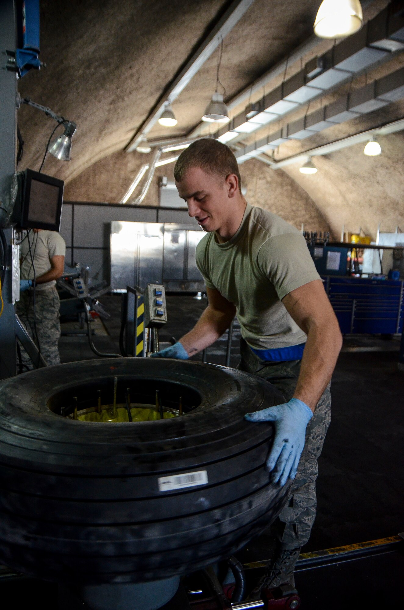 Senior Airman Adam Kern inspects a tire which will be used on a C-130J Super Hercules at the 379th Air Expeditionary Wing, Dec. 31, 2013. Kern is a 379th Expeditionary Maintenance Squadron wheel and tire technician and is part of an 8-man shop which fixes and maintains all aircraft wheels for the base. Kern is deployed from Joint Base Pearl Harbor-Hickam, Hawaii, and is a Waynesville, N.C. native. (U.S. Air Force photo/Senior Airman Jared Trimarchi)