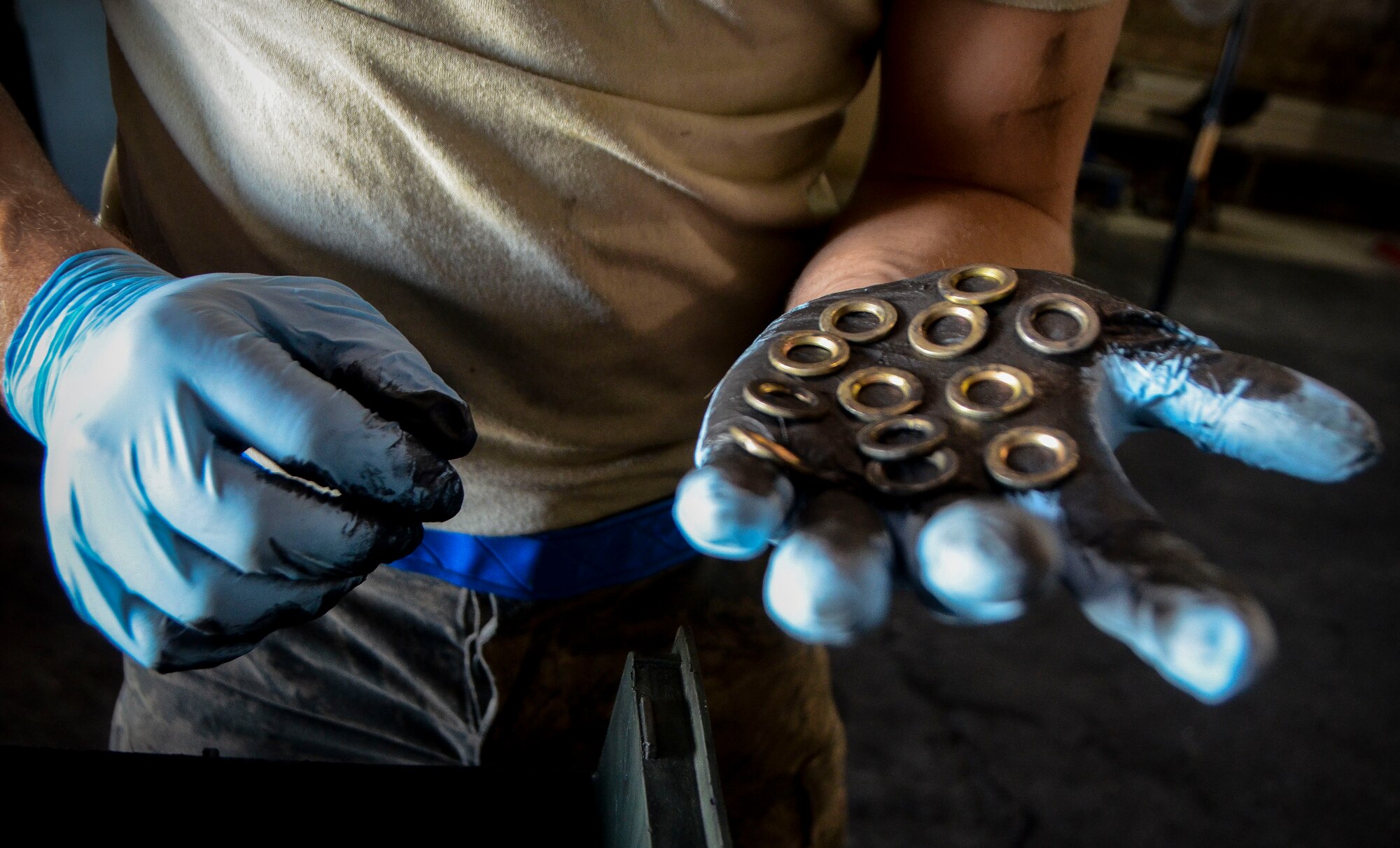 Senior Airman Adam Kern counts washers used on a front wheel of a C-130J Super Hercules at the 379th Air Expeditionary Wing, Dec. 31, 2013. Kern is a 379th Expeditionary Maintenance Squadron wheel and tire technician and is part of an 8-man shop which fixes and maintains all aircraft wheels for the base. Kern is deployed from Joint Base Pearl Harbor-Hickam, Hawaii, and is a Waynesville, N.C. native. (U.S. Air Force photo/Senior Airman Jared Trimarchi)