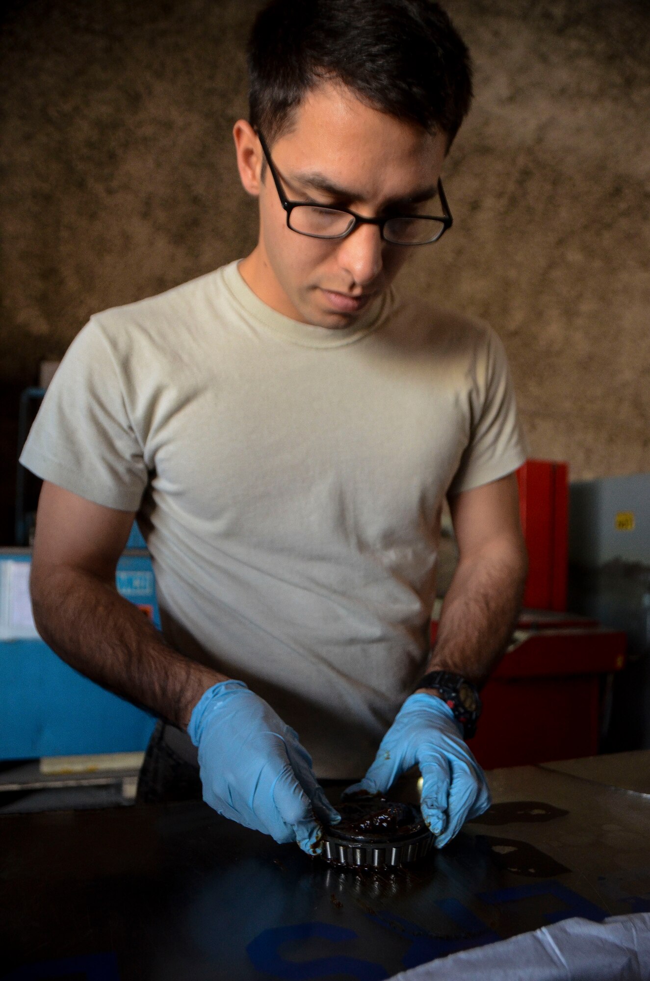 Airman 1st Class Michael Galvan greases a wheel bearing of a C-130J Super Hercules at the 379th Air Expeditionary Wing, Dec. 31, 2013. Galvan is a 379th Expeditionary Maintenance Squadron wheel and tire technician and is part of an 8-man shop which fixes and maintains all aircraft wheels for the base. Galvan is deployed from Joint Base Pearl Harbor-Hickam, Hawaii, and is a Santa Ana, Calif. native. (U.S. Air Force photo/Senior Airman Jared Trimarchi)