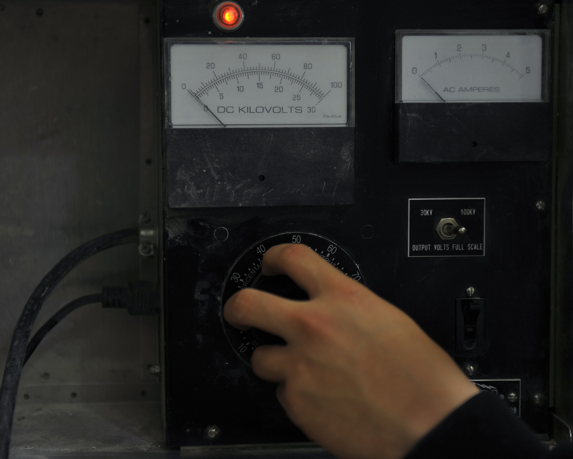 Senior Airman Justin Henke controls power during glove testing at the 379th Air Expeditionary Wing, Southwest Asia, Dec. 30, 2013. Henke has tested 62 pairs of gloves since Dec. 23 which is a requirement for all gloves received and in current inventory. Gloves used daily are tested every six months or sooner if a glove is turned in for inspection. Henke is a 379th Expeditionary Civil Engineer Squadron electrical systems journeyman deployed from Ramstein Air Base, Germany and a Vicksburg, Miss., native. (U.S. Air Force photo by Master Sgt. David Miller)
