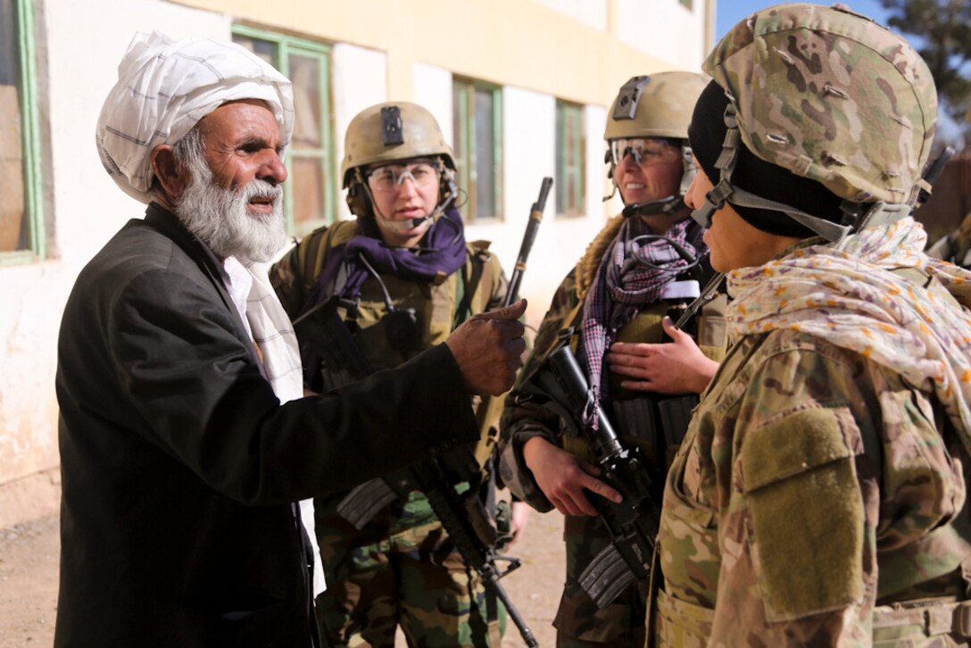 Members of the Afghan army’s 4th Special Operations Kandak and a U.S. Army cultural support team visit a village in Shindand district, Herat province, Afghanistan, to deliver school supplies to an all-female school and provide humanitarian aid, Dec. 28, 2013. 