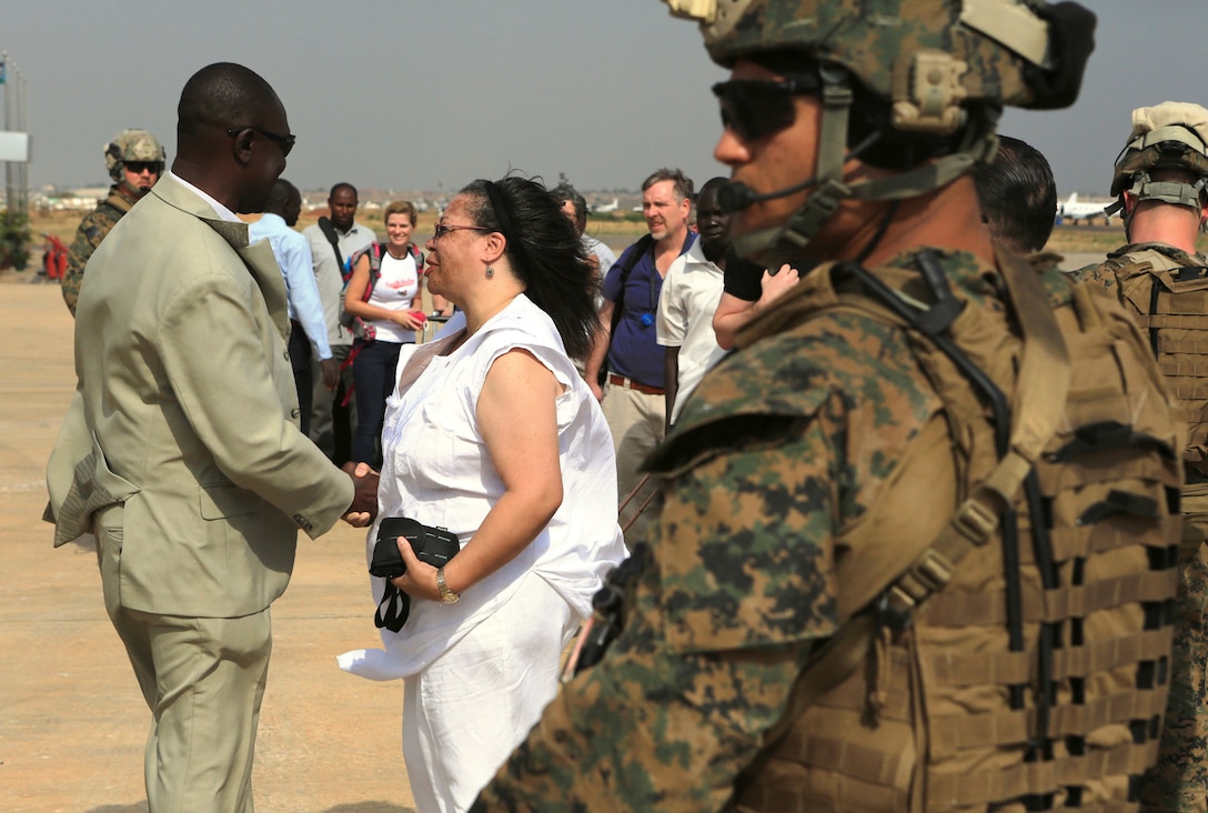Susan D. Page, U.S. ambassador to South Sudan, right, shakes hands with a local delegate on the flight line in Juba, South Sudan, during an evacuation of U.S. Embassy personnel, Jan. 3, 2014. 