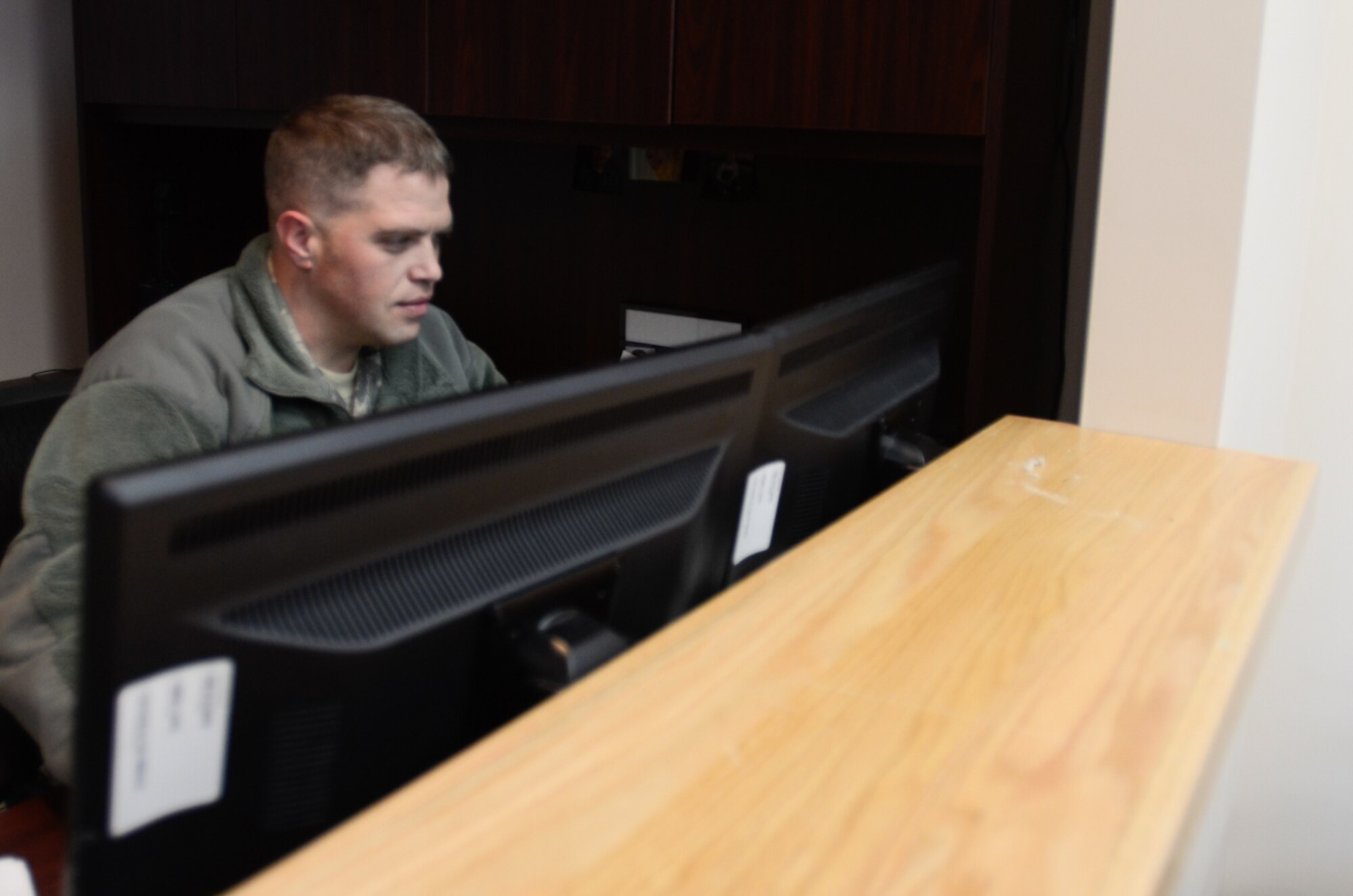 U.S. Air Force Tech. Sgt. Matt Martindell, assigned to the 139th Security Forces Squadron, Missouri Air National Guard, sits at the front desk at the 139th Airlift Wing’s new visitor center at Rosecrans Air National Guard Base, Mo., Jan. 3, 2014.  The Visitor Center issue visitor’s passes to non-base personnel after a background check. (U.S. Air National Guard photo by Tech. Sgt. Theo Ramsey/Released)