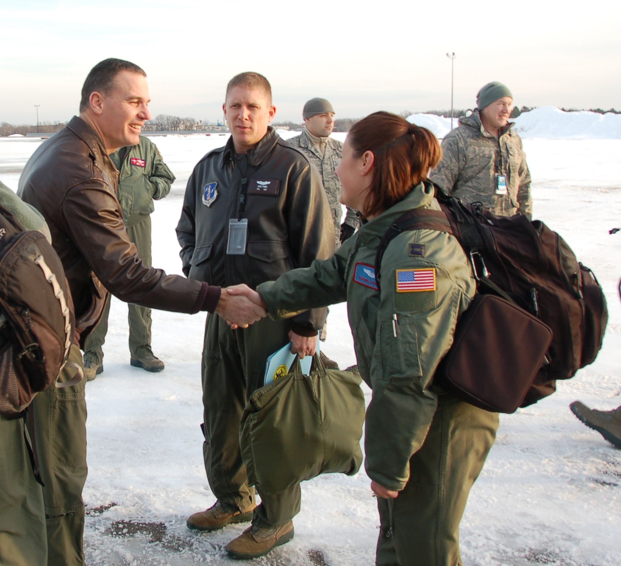Col. Frank Detorie, commander of the 103rd Airlift Wing, greets Capt. Rachel Leimbach, a navigator assigned to the 139th Airlift Squadron, moments before the launch of the first locally-generated sortie aboard a C-130H Hercules aircraft Dec. 19, 2013, at Bradley Air National Guard Base, East Granby, Conn. The aircrew was comprised of Airmen from the Connecticut Air National Guard, the New York Air National Guard and the U.S.A.F.    (U.S. Air National Guard photo by Maj. Bryon Turner)