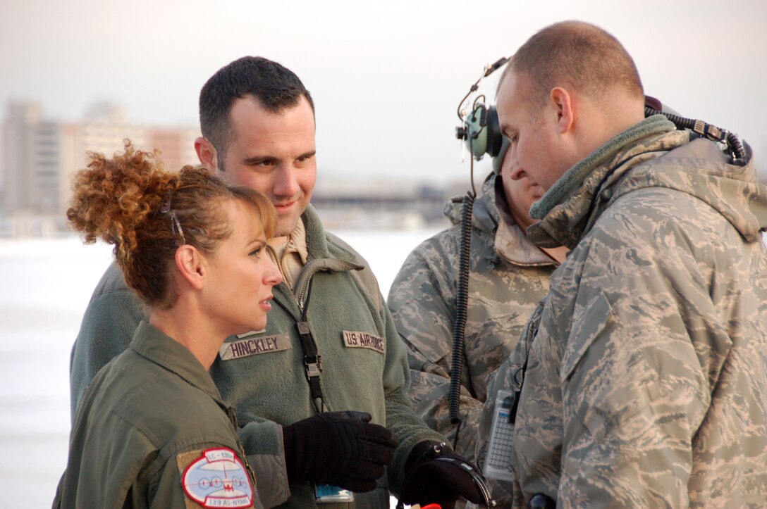 Master Sgt. Jean Booth, a loadmaster assigned to the 139th Airlift Squadron, Tech. Sgt. Brian Hinckley and Master Sgt. Jon Favreau, crew chiefs assigned to the 103rd Maintenance Group, complete pre-flight preparations for the first locally-generated sortie aboard a C-130H Hercules aircraft Dec. 19, 2013, at Bradley Air National Guard Base, East Granby, Conn.  The aircrew was comprised of Airmen from the Connecticut Air National Guard, the New York Air National Guard and the U.S.A.F.  (U.S. Air National Guard photo by Maj. Bryon Turner)