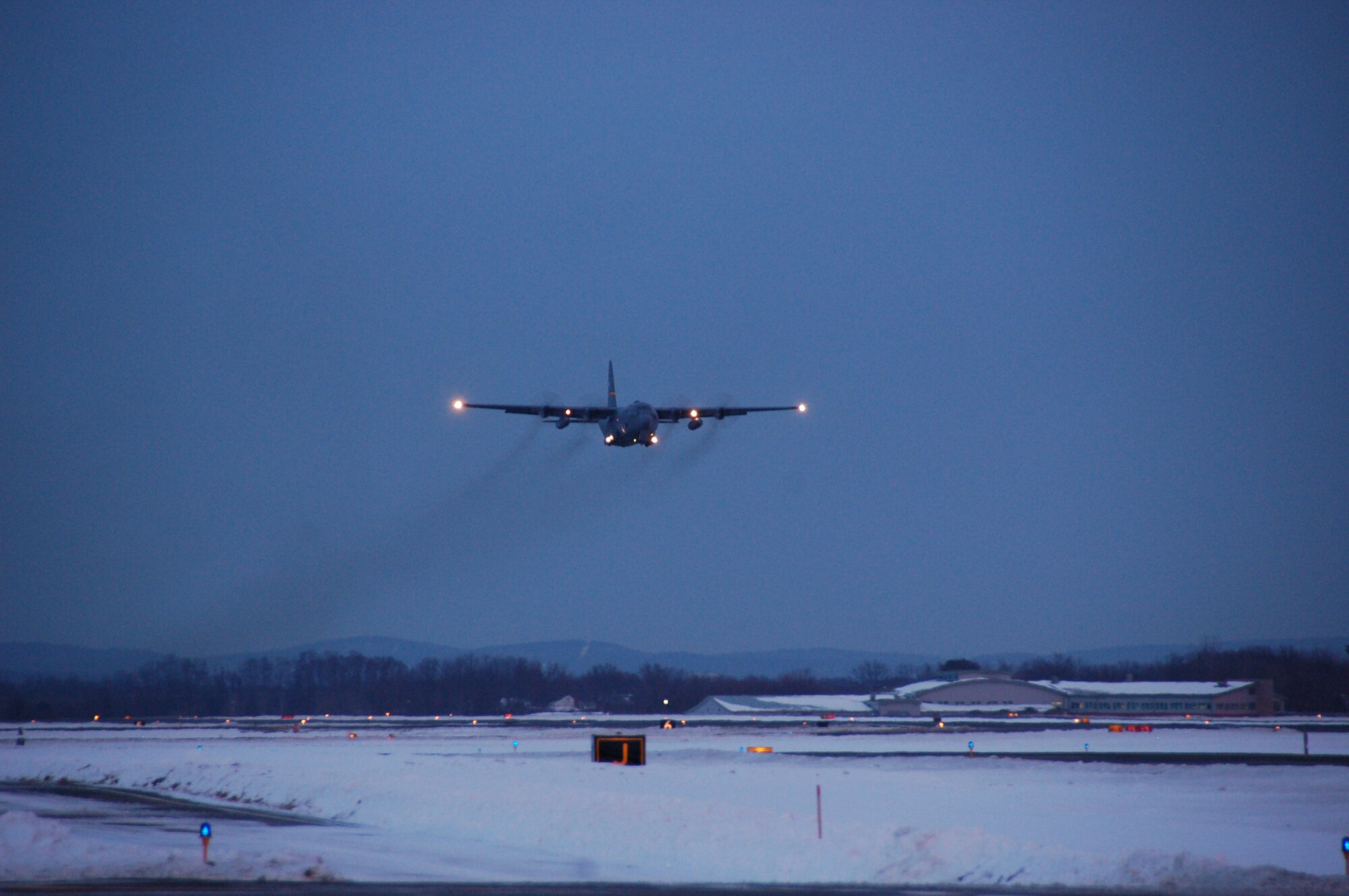 A C-130H Hercules aircraft assigned to the 103rd Airlift Wing lifts off Dec. 19, 2013, marking the first locally-generated sortie with the unit’s new airframe at Bradley Air National Guard Base, East Granby, Conn.  (U.S. Air National Guard photo by Maj. Bryon Turner)