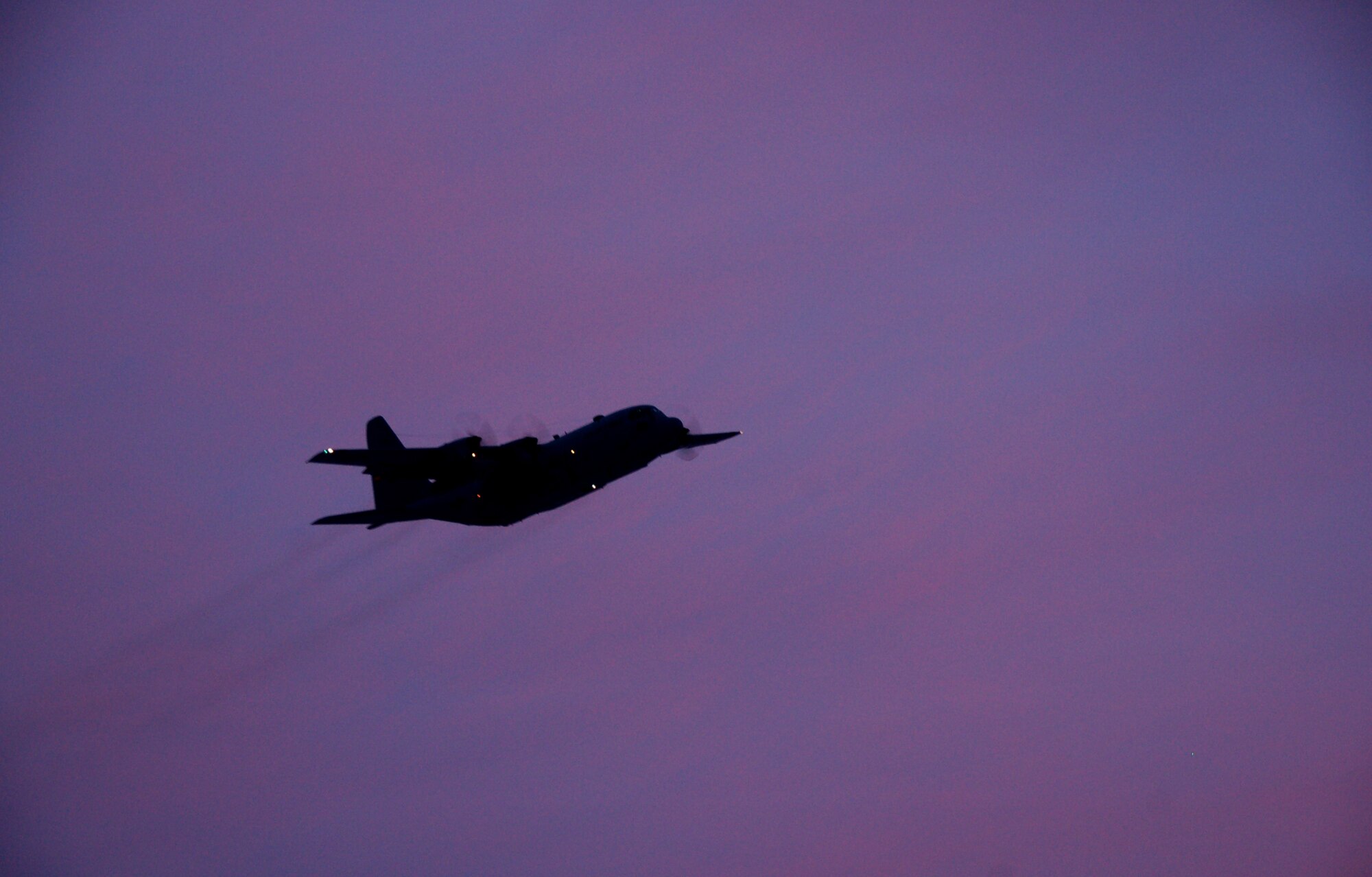 A C-130H Hercules aircraft assigned to the 103rd Airlift Wing flies off into the sunset at Bradley Air National Guard Base, East Granby, Conn., Dec. 19, 2013, marking the historic, first locally-generated sortie with the unit’s newly assigned airframe.  (U.S. Air National Guard photo by Maj. Bryon Turner)