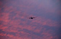 A C-130H Hercules aircraft assigned to the 103rd Airlift Wing flies off into the sunset at Bradley Air National Guard Base, East Granby, Conn., Dec. 19, 2013, marking the historic, first locally-generated sortie with the unit’s newly assigned airframe.  (U.S. Air National Guard photo by Maj. Bryon Turner)