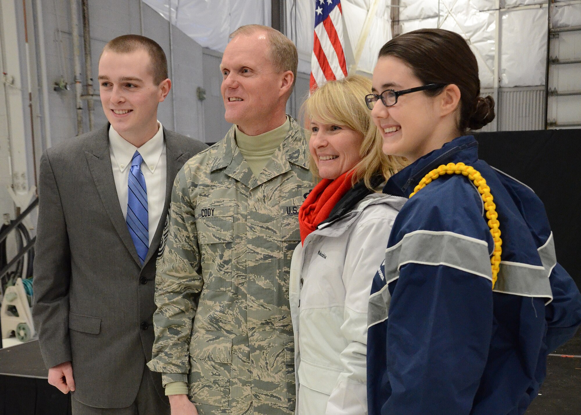 PEASE AIR NATIONAL GUARD BASE, N.H. -- Billy Toth, Chief Master Sgt. of the Air Force James Cody, Athena Cody, Ashlyn Correia (left to right) pose for a picture Jan. 4, 2014 on Pease Air National Guard Base, Portsmouth N.H. The Air Force's most senior enlisted member visited Pease ANGB to speak with enlisted Airmen and observe the unique capability they provide to the state of New Hampshire and the Air Force. (N.H. National Guard photo by Airman 1st Class Kayla M. McWalter/Released)