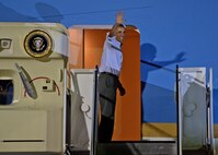 President of the United States Barack Obama waves to servicemembers and their families at Joint Base Pearl Harbor-Hickam, Hawaii, while boarding Air Force One, Jan. 4, 2014. President Obama and daughters Sasha and Malia are on their way back to Washington D.C., after a 15-day family vacation for the holidays. (U.S. Air Force photo/Staff Sgt. Alex Martinez)