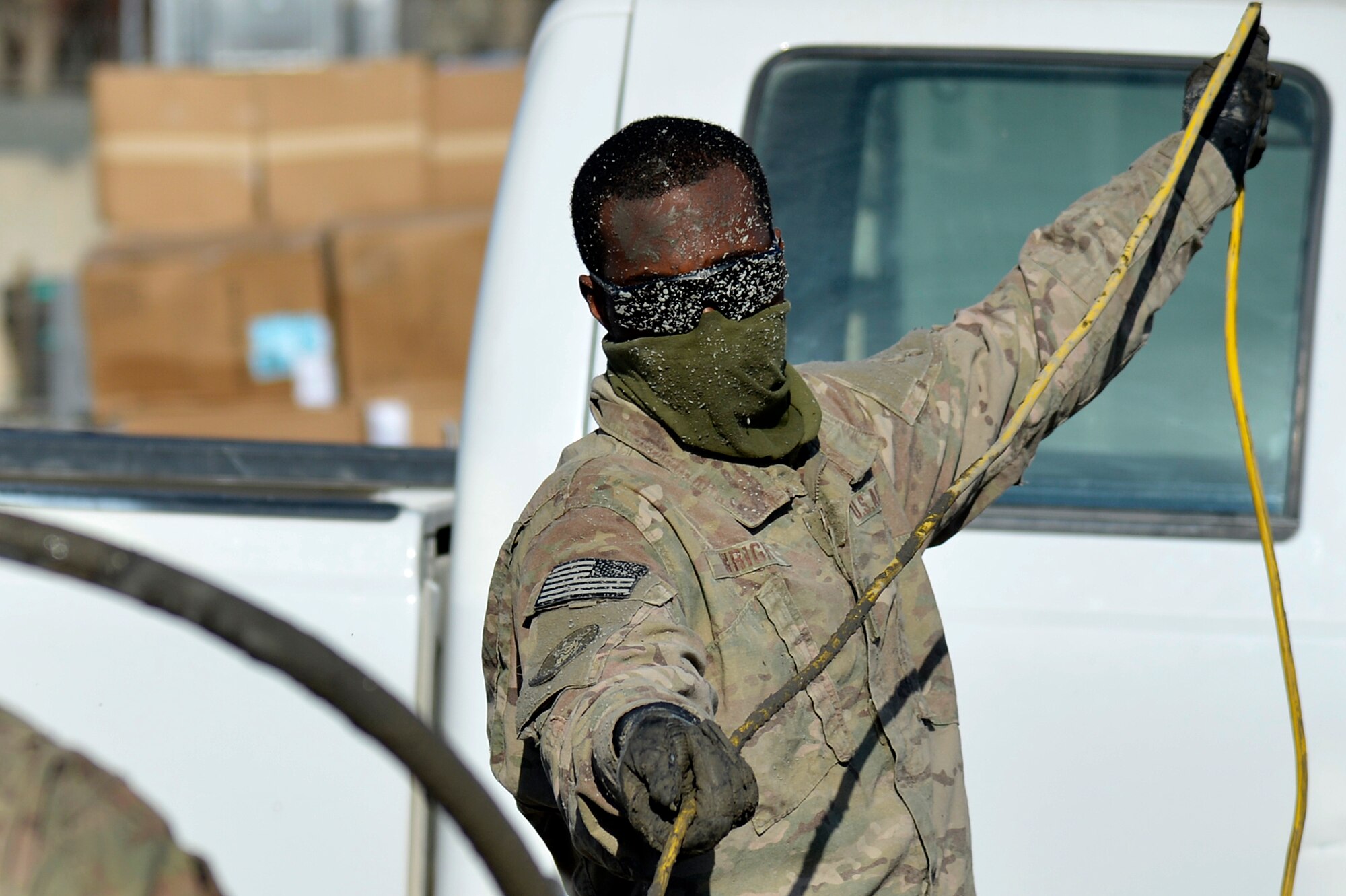 U.S. Air Force Senior Airman Andrew Wright, 577th Expeditionary Prime BEEF Squadron electrician, assists with pouring concrete at Kandahar Airfield, Afghanistan, Jan. 4, 2014. The 577th EPBS is forward deployed from the 1st Expeditionary Civil Engineer Group at Al Udeid Air Base. (U.S. Air Force photo by Senior Airman Kayla Newman/Released)