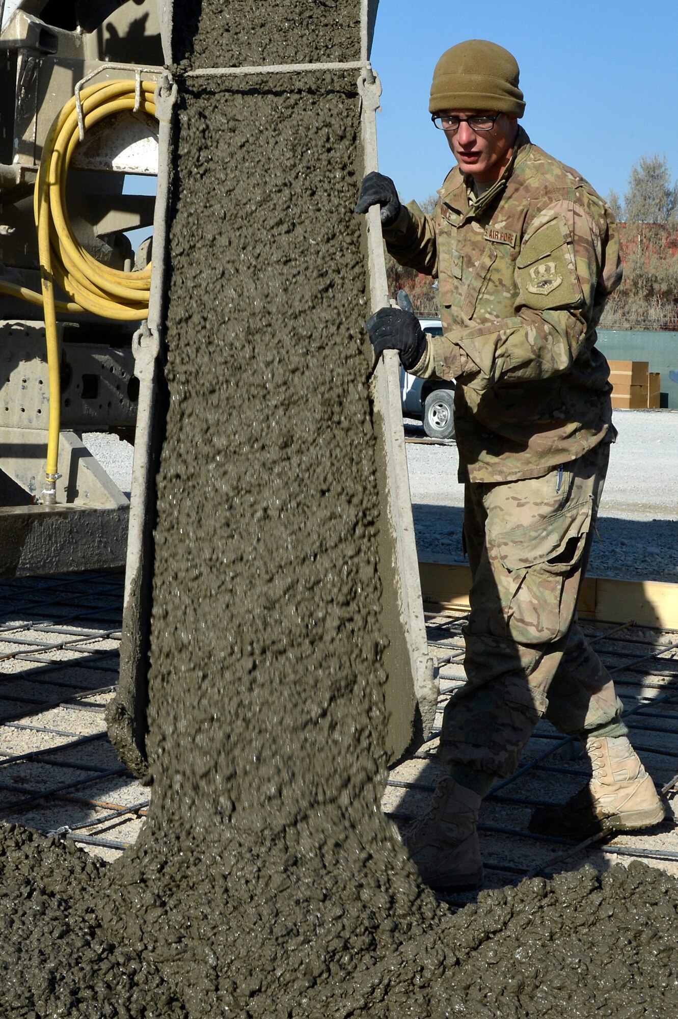 U.S. Air Force Airman 1st Class Austen Windle, 577th Expeditionary Prime BEEF Squadron pavements and equipment operator, pour a concrete foundation at Kandahar Airfield, Afghanistan, Jan. 4, 2014. The 577th EPBS is forward deployed from the 1st Expeditionary Civil Engineer Group at Al Udeid Air Base. (U.S. Air Force photo by Senior Airman Kayla Newman/Released)