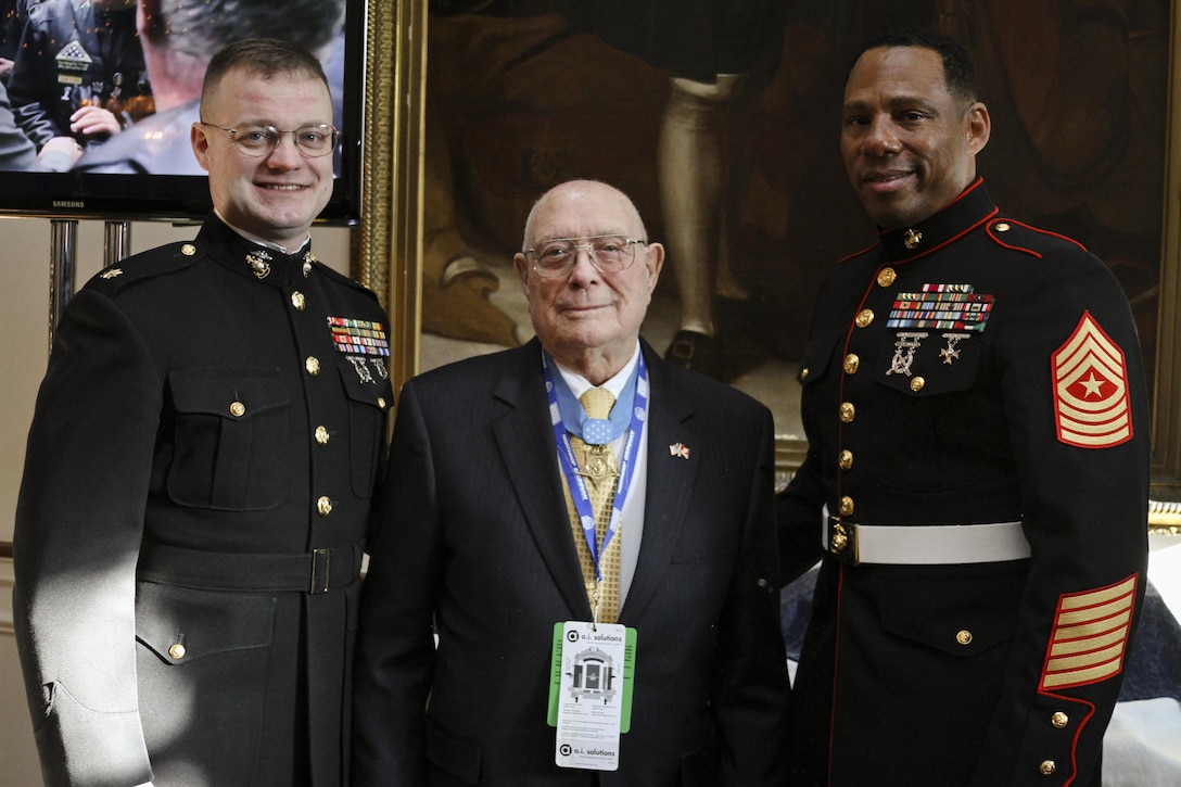 Medal of Honor recipient Hershel “Woody” Williams poses with U.S. Marine Corps Maj. Christopher S. Conner, the commanding officer of Marine Corps Recruiting Station Baltimore and a native of Gastonia, N.C., and U.S. Marine Corps Sgt. Maj. Brian Taylor, the sergeant major for RS Baltimore and a native of Brooklyn, N.Y., at the governor’s mansion in Annapolis, Md., Dec. 27, 2013. Maryland governor Martin O’Malley hosted a breakfast at his home to honor five Medal of Honor recipients prior to the Military Bowl, a college football game that was held in Annapolis the same day. Williams, a native of Fairmont, W.V., was awarded the Medal of Honor for his actions during the Battle of Iwo Jima when on Feb. 23, 1945, he single-handedly took out several enemy machine gun positions with a flamethrower.  (U.S. Marine Corps photo by Cpl. Bryan Nygaard/Released).