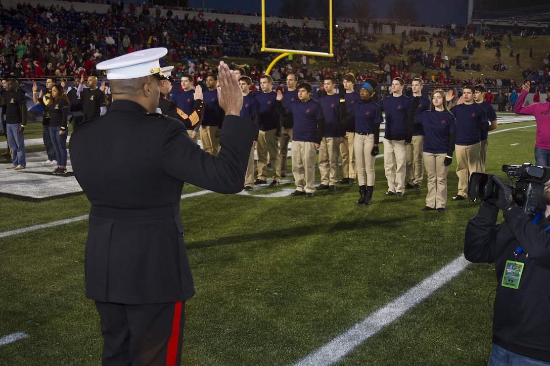 U.S. Marine Corps Maj. Gen. Vincent R. Stewart, the commanding general of Marine Forces Cyber Command, administers the oath of enlistment to 15 members of Marine Corps Recruiting Station Baltimore’s delayed entry program during the Military Bowl, which was played at Navy-Marine Corps Memorial Stadium in Annapolis, Md., Dec. 27, 2013. There were 15 new recruits from each of the armed services present for the oath of enlistment ceremony. (U.S. Marine Corps photo by Cpl. Bryan Nygaard/Released).