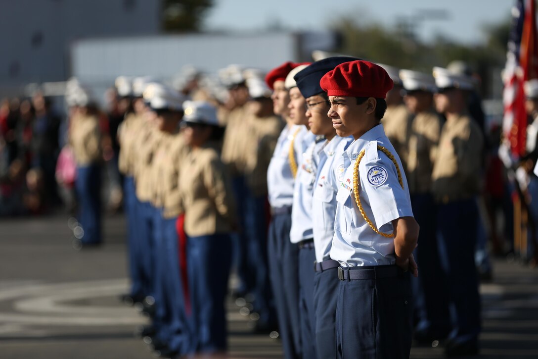 Cadets from San Marcos High School Air Force JROTC stand together with Marines from Marine Aircraft Group (MAG) 39 at Carillo Elementary School, Dec. 20. The elementary school held a large donation of goods for the Marines, and held performances by the students including singing and dancing.



