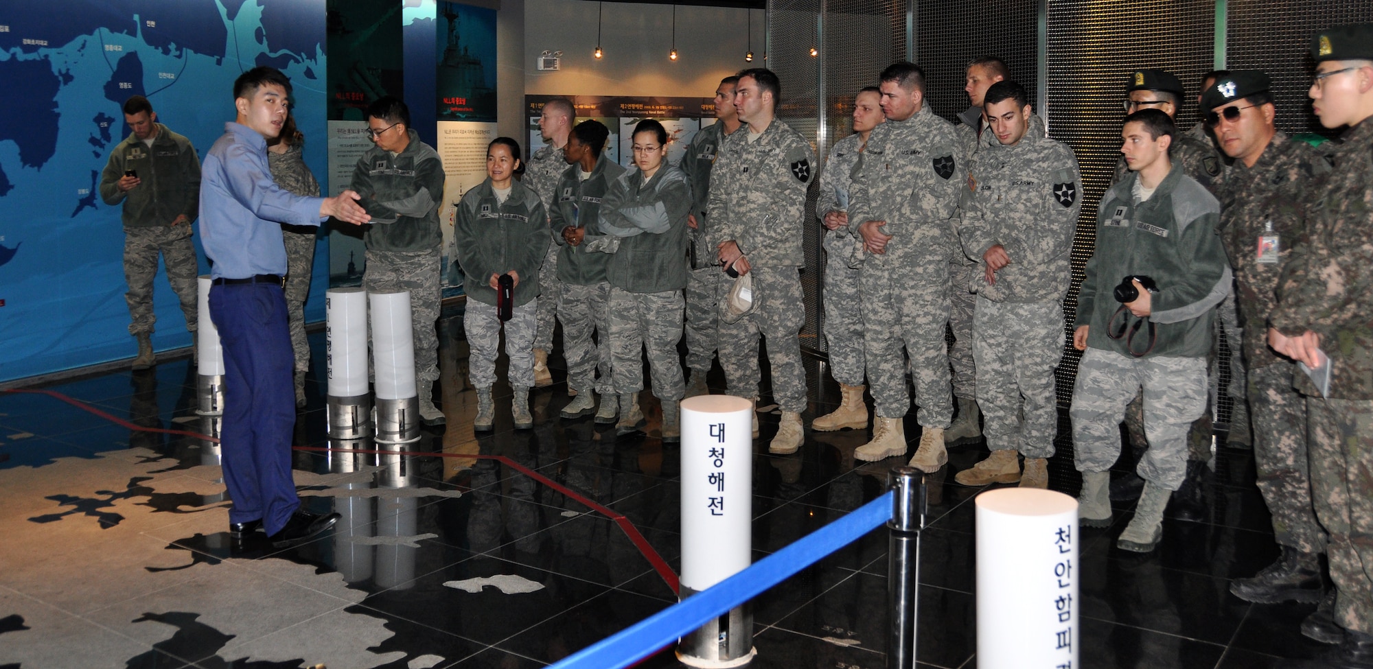A tour guide gives U.S. and Republic of Korea Officers a tour of the ROK navy 2nd Fleet Command museum, Pyeongtaek, ROK, Jan. 3, 2014. More than 40 company grade officers from U.S. Army Garrison Humphreys, the ROK army 4th Battalion and the ROK air force Operations Center toured the ROK Second Naval Fleet to learn about daily naval operations. (U.S. Air Force photo/Capt. Tamara Fischer-Carter)