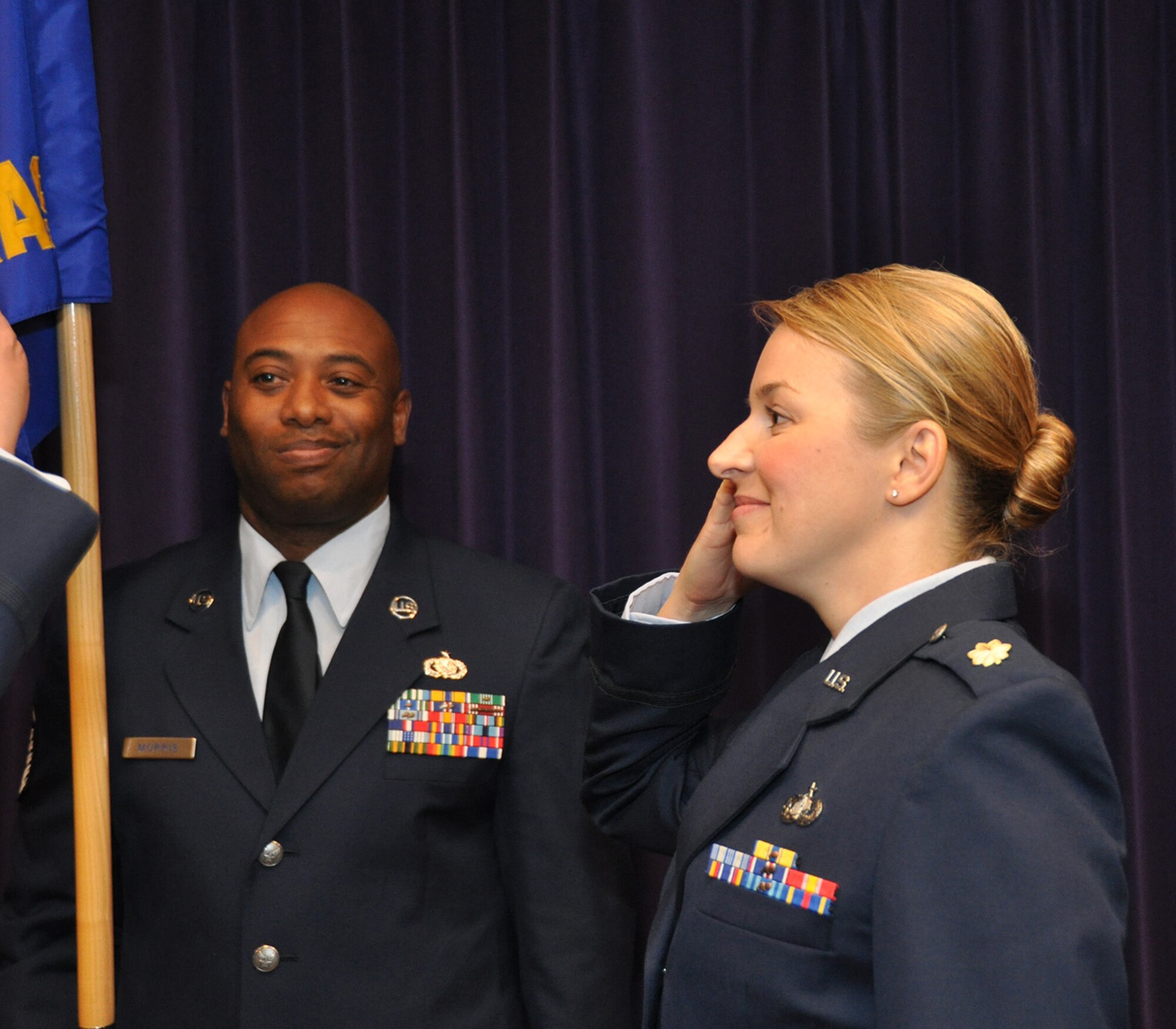 TRAVIS AIR FORCE BASE, Calif. -- Maj Erin Floersch receives the 349th Memorial Affairs Squadron guidon during an assumption of command ceremony officiated by Col. Stuart Toft, 349th Mission Support Group commander, Jan. 5.   Floersch officially took command of the squadron Nov. 2, 2013. (U.S. Air Force photo/Senior Master Sgt. Robert Wade)