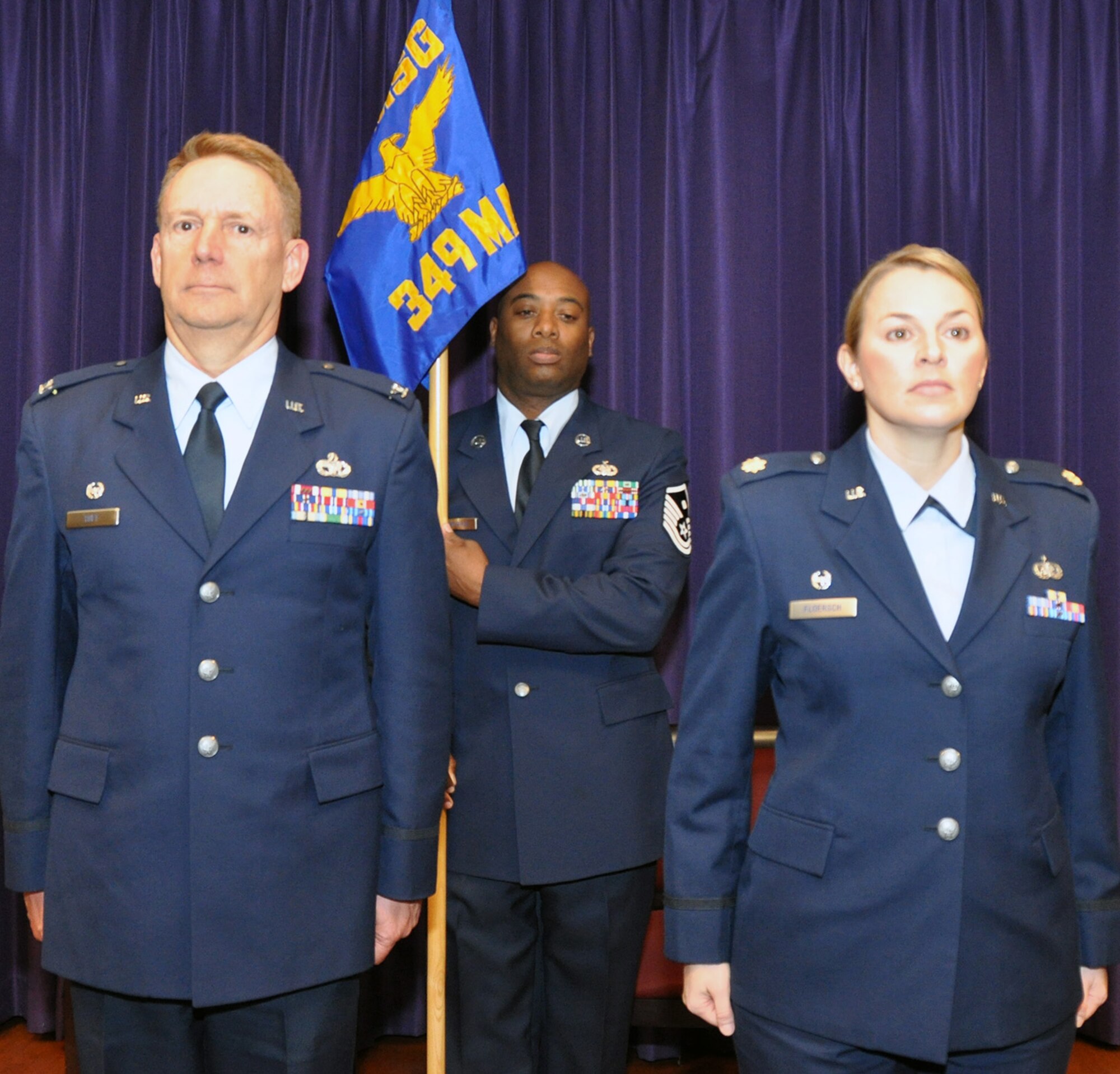 TRAVIS AIR FORCE BASE, Calif. -- Maj Erin Floersch receives the 349th Memorial Affairs Squadron guidon during an assumption of command ceremony officiated by Col. Stuart Toft, 349th Mission Support Group commander, Jan. 5.   Floersch officially took command of the squadron Nov. 2, 2013. (U.S. Air Force photo/Senior Master Sgt. Robert Wade)