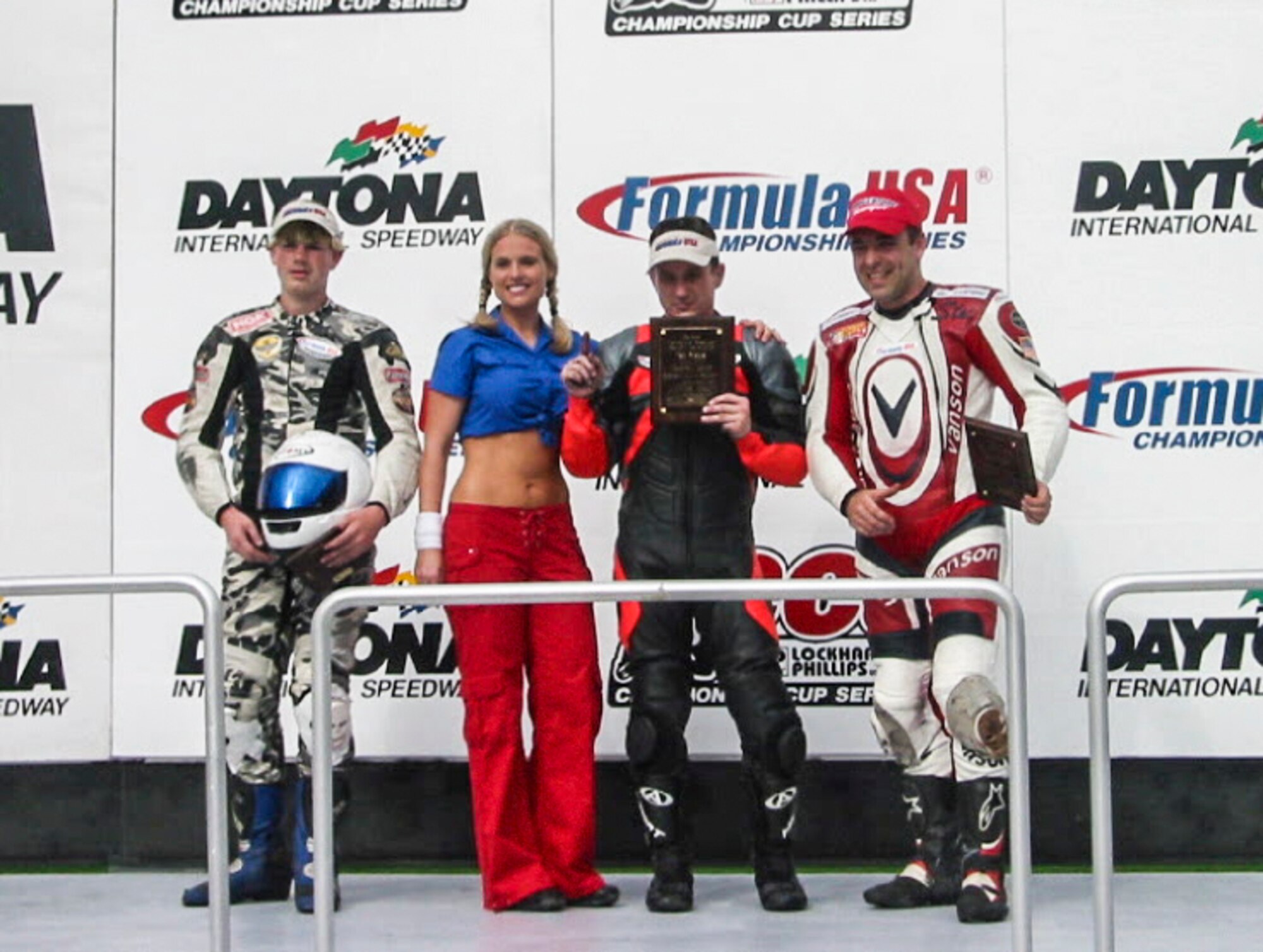 Lt. Col. Stewart Aitken-Cade, Aerospace Data Facility-Colorado, right, receives and award after competing in a motorcycle race. Aitken-Cade has been riding motorcycles for nearly two decades and has won four national championships. (Courtesy Photo)