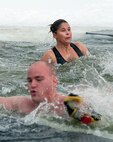 Swimmers scramble to get out of the icy waters of Sloan Lake, Cheyenne, Wyo., during the second-annual Matthew S. Schwartz Memorial Polar Plunge Jan. 4, 2013. Participants braved 16-degree air and 30-degree water temperatures to raise money for a foundation established to help wounded explosive ordnance technicians and their families. The event is named for an F.E. Warren Air Force Base, Wyo., 90th Civil Engineer Squadron explosive ordnance technician who was killed in action while deployed to Afghanistan Jan. 5, 2012. (U.S. Air Force photo by R.J. Oriez)