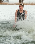 Tech. Sgt. Cara McQueen, 90th Medical Operations Squadron Public Health, into the icy waters of Sloan Lake, Cheyenne, Wyo., during the second-annual Matthew S. Schwartz Memorial Polar Plunge Jan. 4, 2013. Participants braved 16-degree air and 30-degree water temperatures to raise money for a foundation established to help wounded explosive ordnance technicians and their families. The event is named for an F.E. Warren Air Force Base, Wyo., 90th Civil Engineer Squadron explosive ordnance technician who was killed in action while deployed to Afghanistan Jan. 5, 2012. (U.S. Air Force photo by R.J. Oriez)