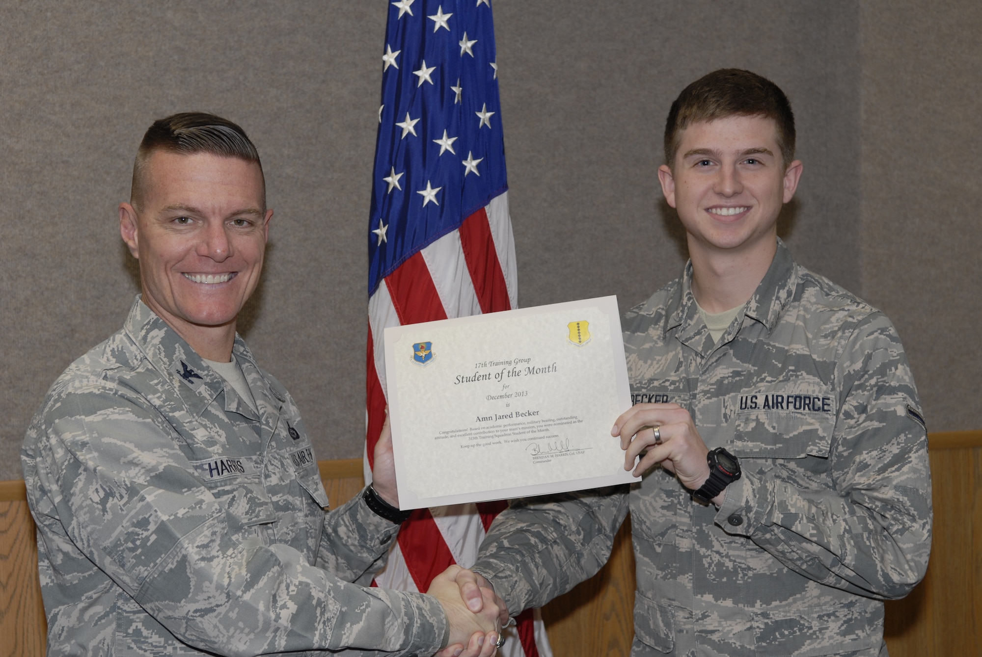 GOODFELLOW AIR FORCE BASE, Texas -- Col. Brendan Harris, 17th Training Group Commander, presents the 315th Training Squadron Enlisted Student of the Month award for December 2013 Airman Jared L. Becker Jan. 3. (U.S. Air Force photo Lucian Czarnecki)